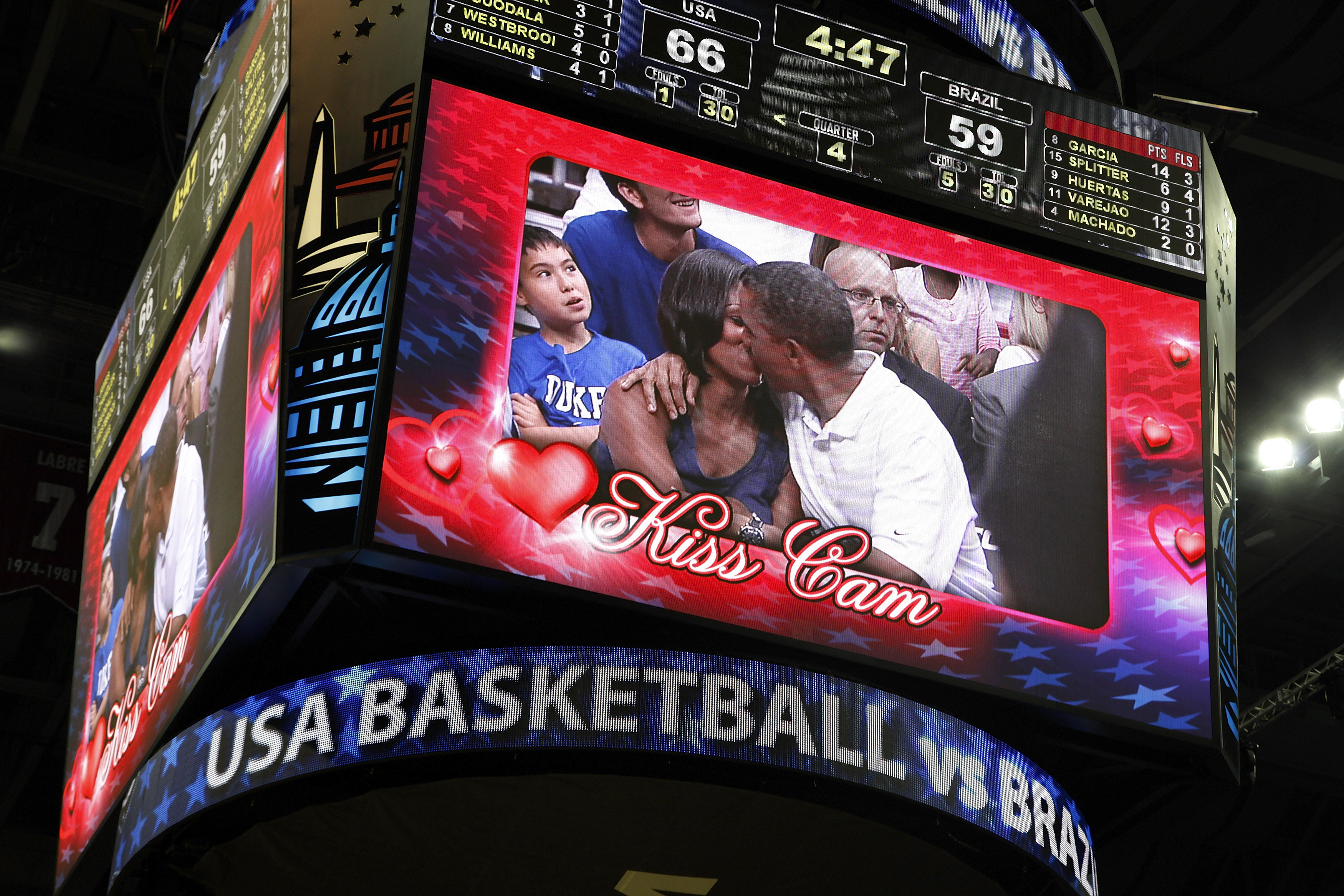 President Barack Obama and first lady Michelle Obama are shown kissing on the kiss cam screen during a timeout in the Olympic basketball exhibition game between the U.S. and Brazil national men's teams in Washington on July 16, 2012.