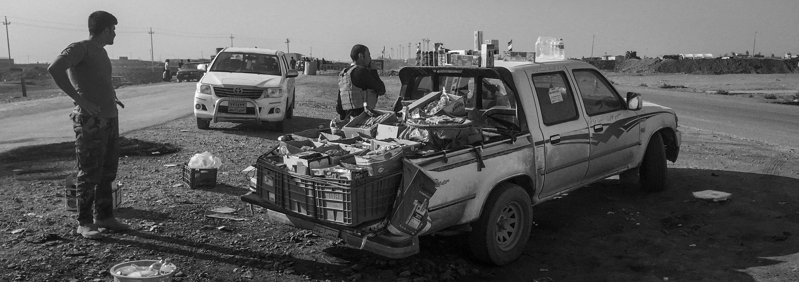 Peshmerga fighters buy snacks from a makeshift store at a checkpoint on the road to Mosul on Nov.&nbsp;7, 2016, in Bartella, Iraq.