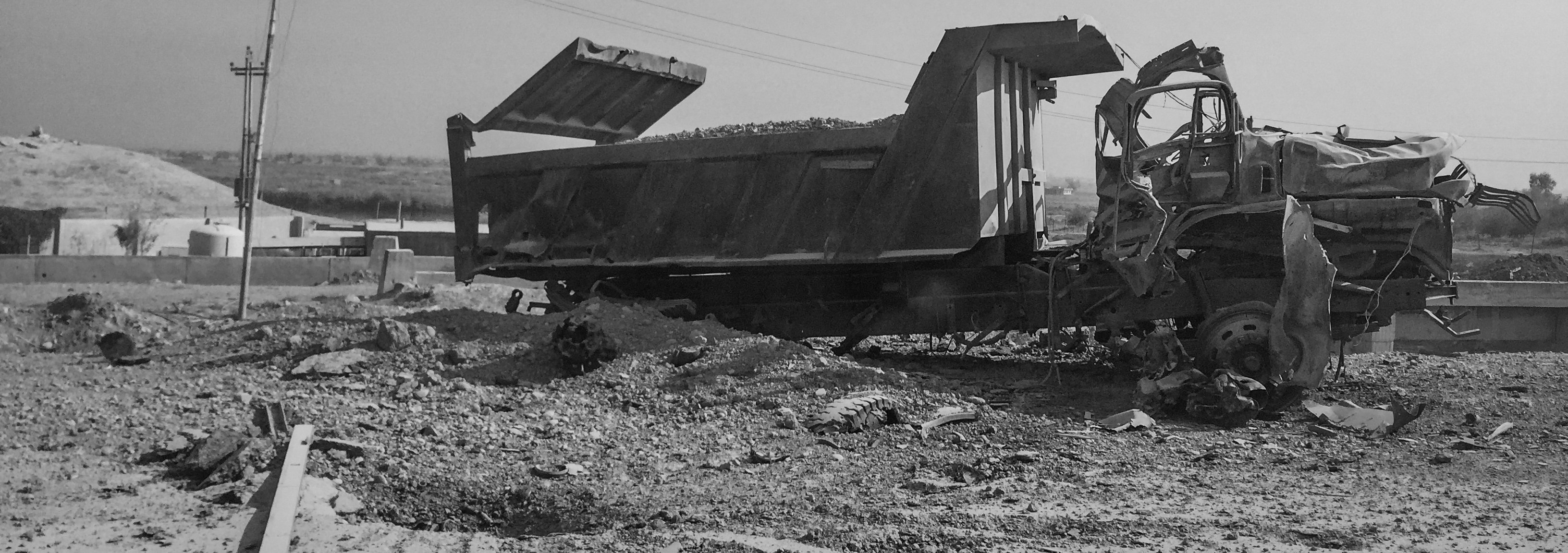 A destroyed vehicle on a road leading to Mosul on Nov. 9, 2016, in Al Qayyarah, Iraq.