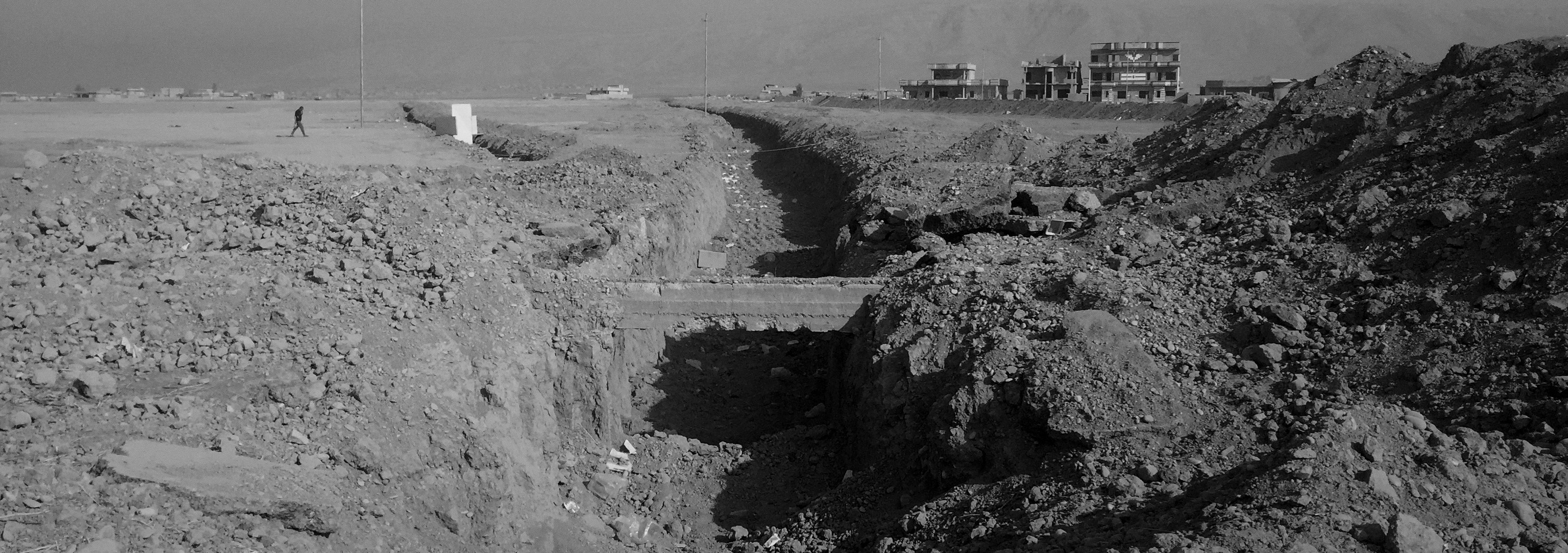 This deep trench is designed to stop suicide vehicles from attacking a checkpoint next to a road leading to Mosul on Nov. 7, 2016, in Bartella, Iraq.