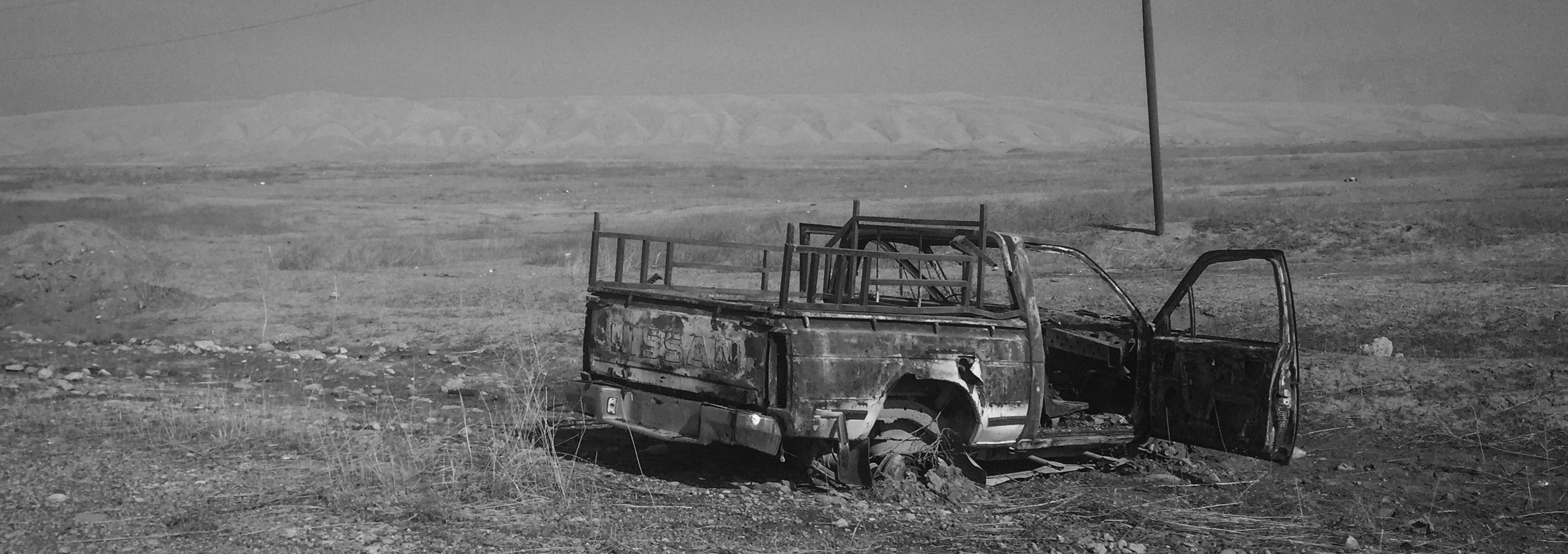 A destroyed vehicle is seen on a road leading to Mosul on November 14, 2016 in Ba'ashiqah, Iraq.&nbsp;