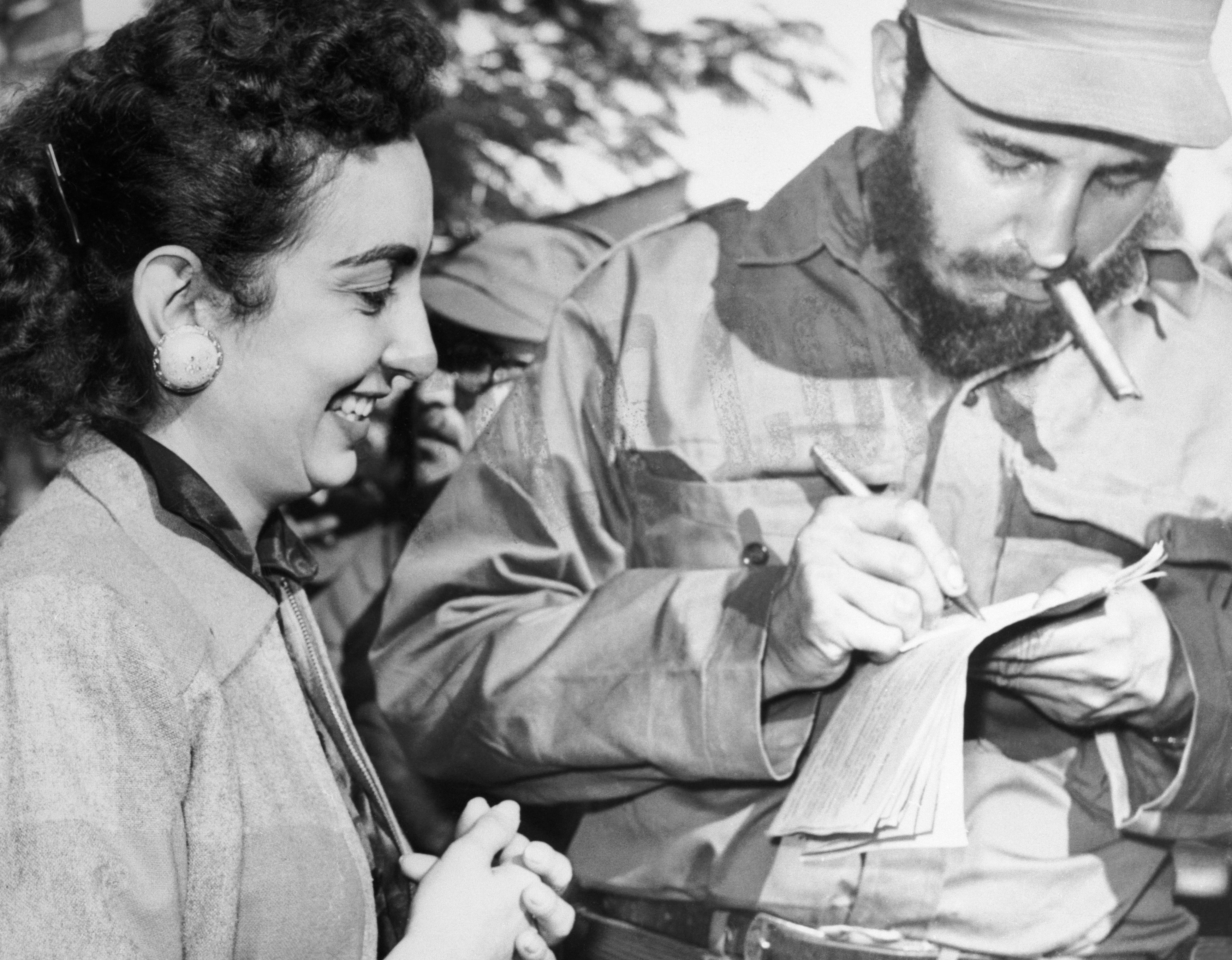 Castro gives an autograph to an admirer in Camaguey, Cuba on Jan. 7, 1959. While Cubans&nbsp;awaited Castro's&nbsp;arrival&nbsp;in&nbsp;Havana, cabinet&nbsp;ministers&nbsp;of&nbsp;the&nbsp;new&nbsp;Cuban&nbsp;government&nbsp;reported&nbsp;to&nbsp;their&nbsp;offices&nbsp;for&nbsp;the&nbsp;first&nbsp;time&nbsp;to&nbsp;begin&nbsp;a&nbsp;new&nbsp;program&nbsp;of&nbsp;reform&nbsp;and&nbsp;reconstruction.