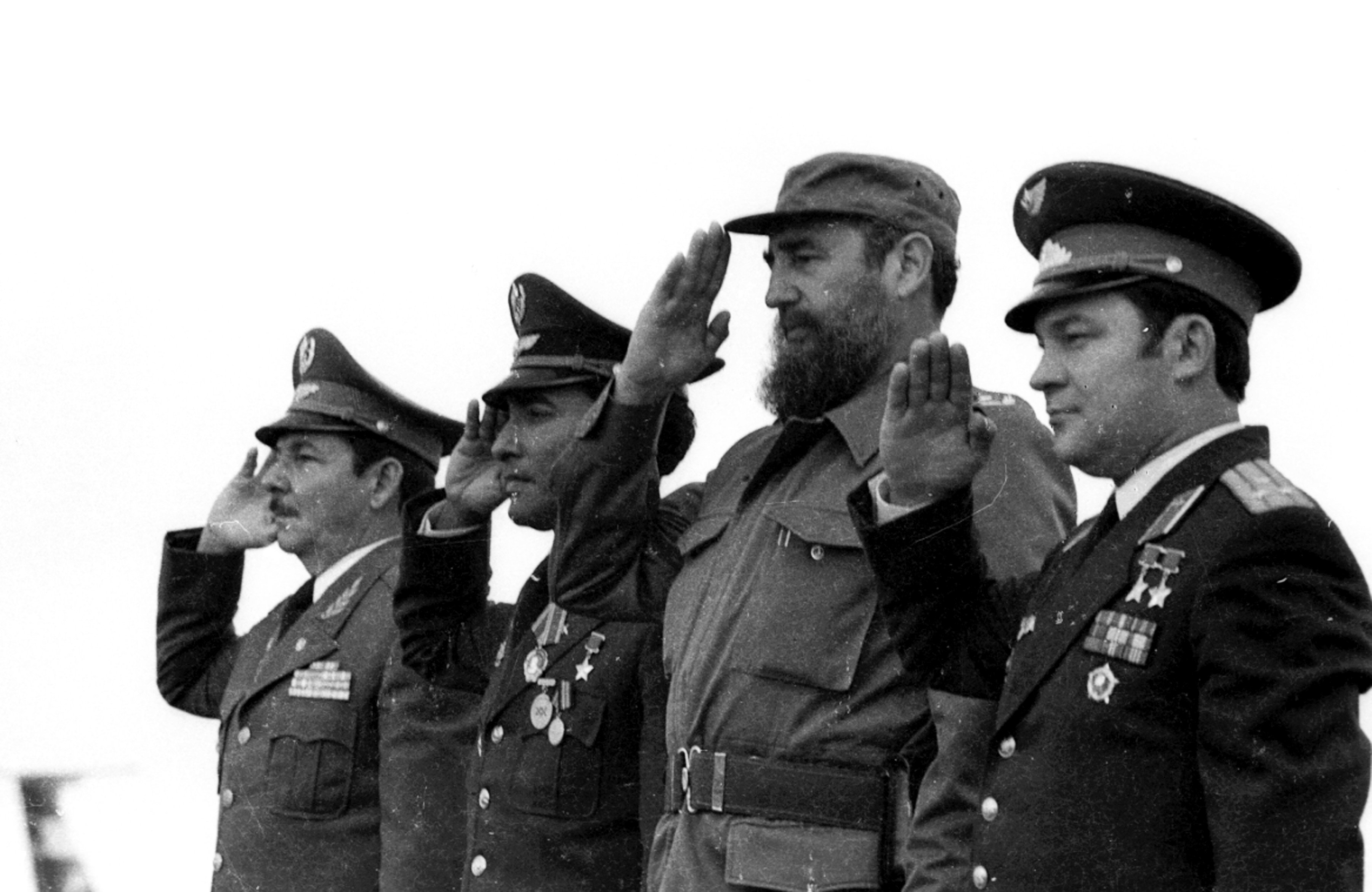 Chief of Cuba's Armed Forces, Raul Castro, Cuba's cosmonaut, Arnaldo Tamayo Mendez, Castro and Soviet cosmonaut Yuri Romanenko stand during a reception ceremony at Havana's Jose Marti airport, October 1980, after the cosmonauts returned from their space mission on Soyuz 38.