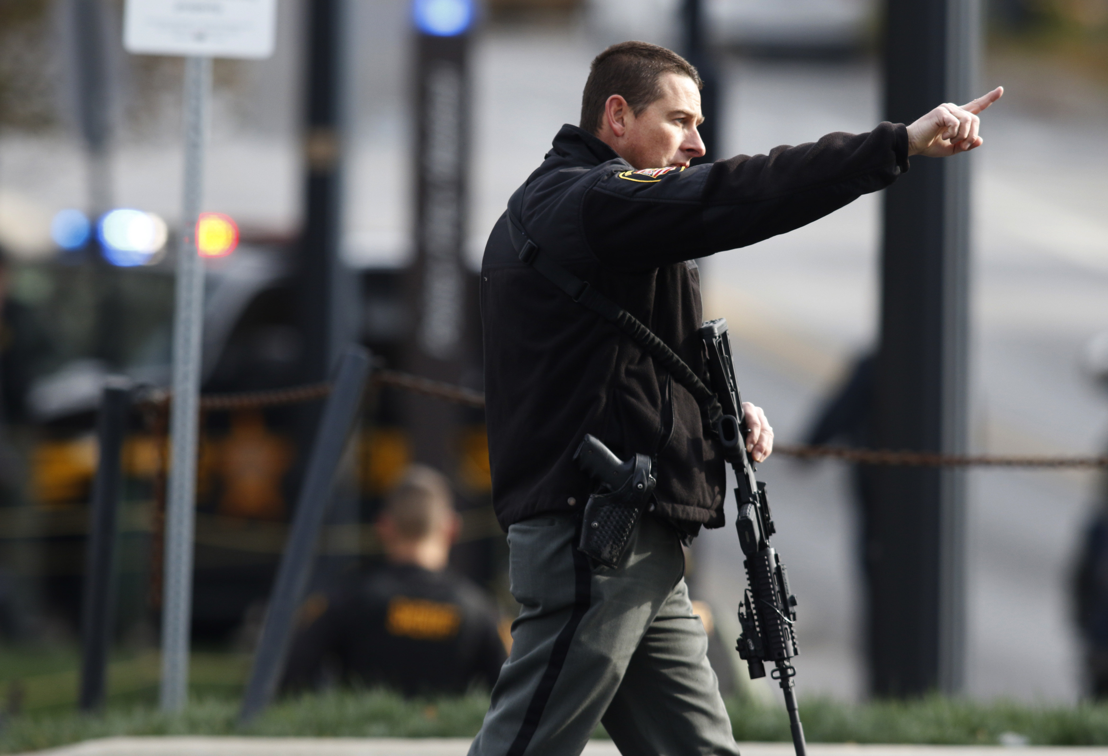 A law enforcement official motions for people to leave the area outside of a parking garage on the campus of Ohio State University as they respond to an active attack in Columbus, Ohio, on November 28, 2016.&nbsp;