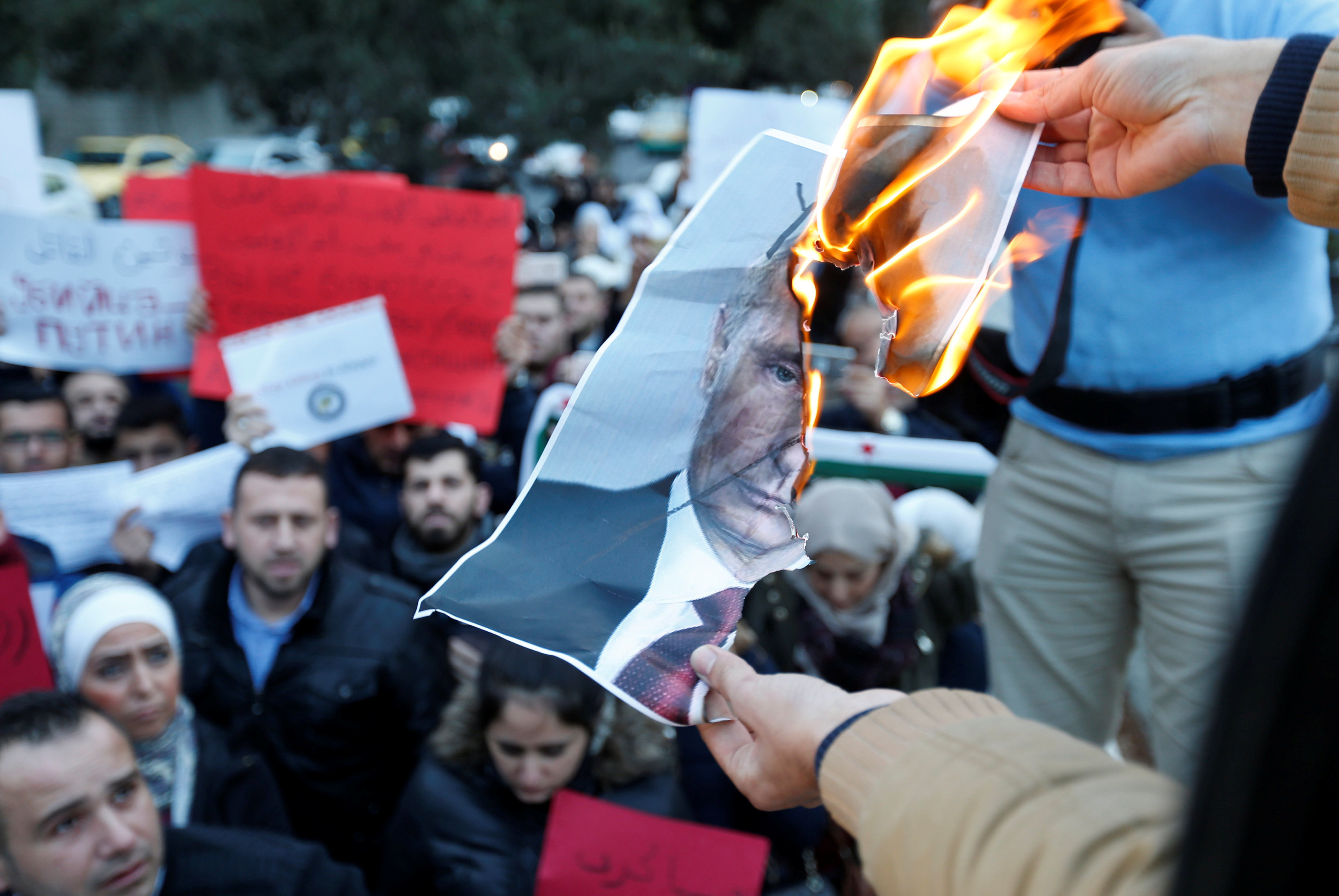 Protesters in front of the Russian Embassy in Amman, Jordan,&nbsp;burn a picture of Russian President Vladimir Putin during a sit-in in solidarity with the people of Aleppo and against Russia's support of the Syrian regime on Dec. 13, 2016.