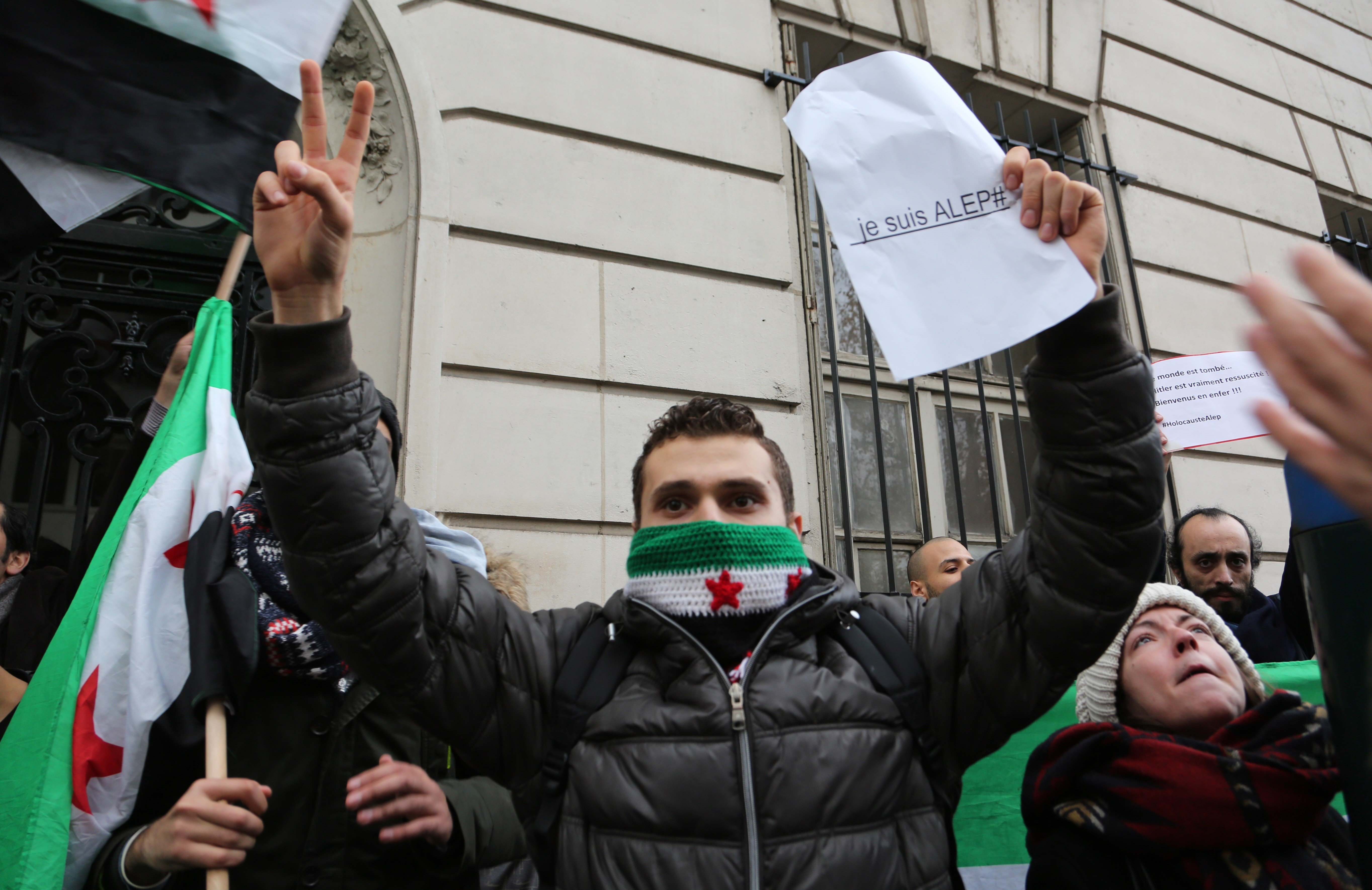 A man holds a sign saying "I am Aleppo" during a protest outside of the&nbsp;Russian Embassy in Paris&nbsp;on Dec. 13, 2016.