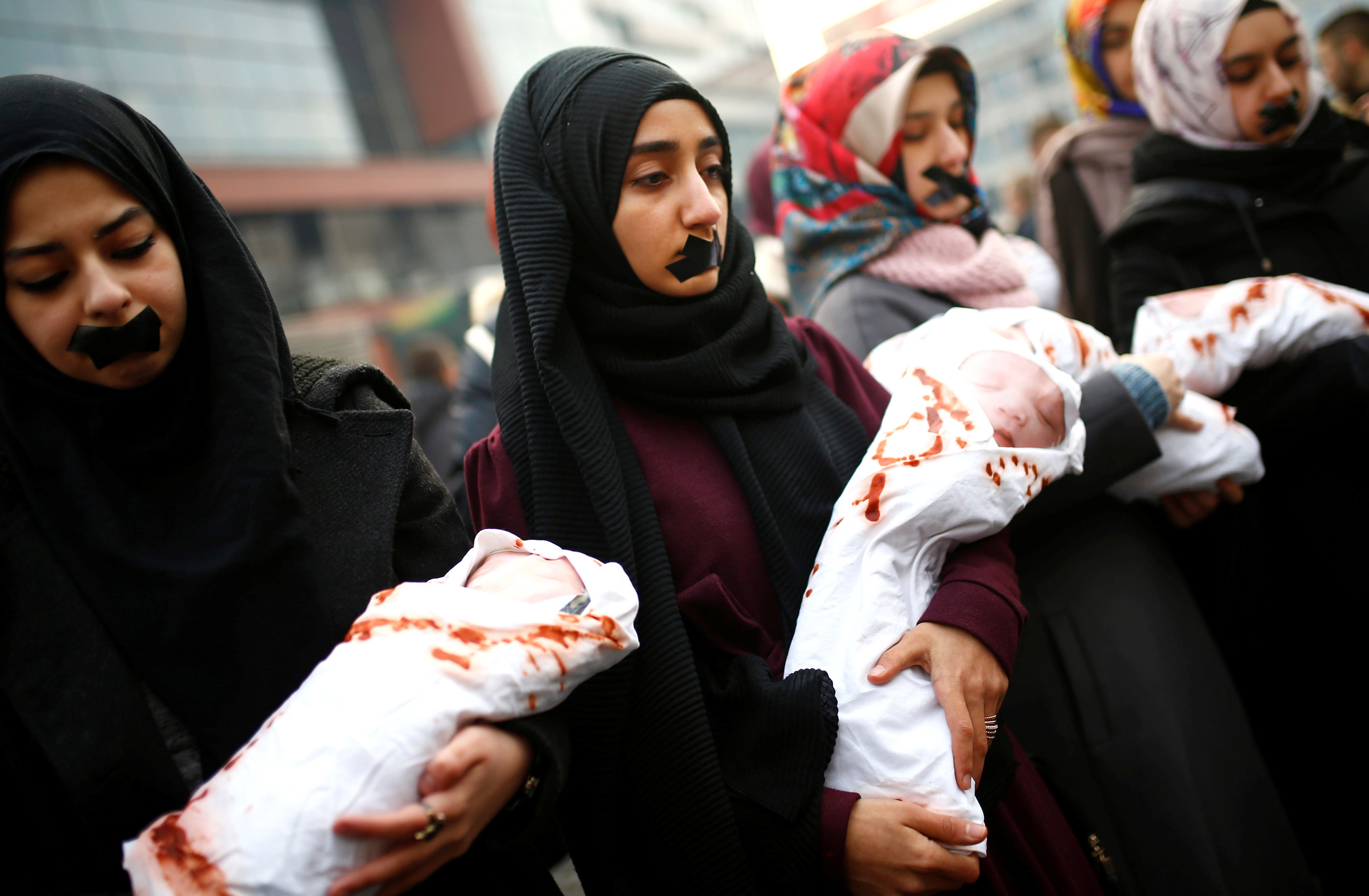 Students hold bundles representing dead babies during a protest in Sarajevo, Bosnia and Herzegovina, to show solidarity with the trapped citizens of Aleppo on Dec. 14, 2016.