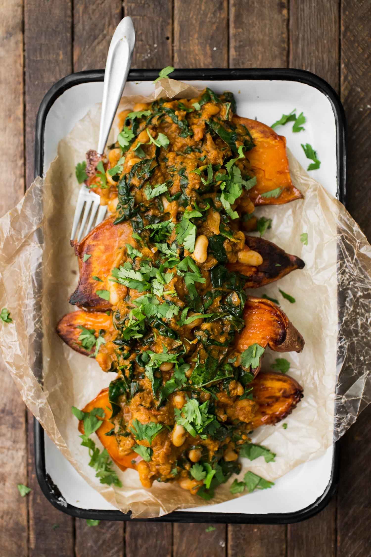 <strong>Get the <a href="https://naturallyella.com/white-bean-masala/" target="_blank">White Bean Masala Smothered Sweet Potatoes recipe</a>&nbsp;from Naturally Ella</strong>