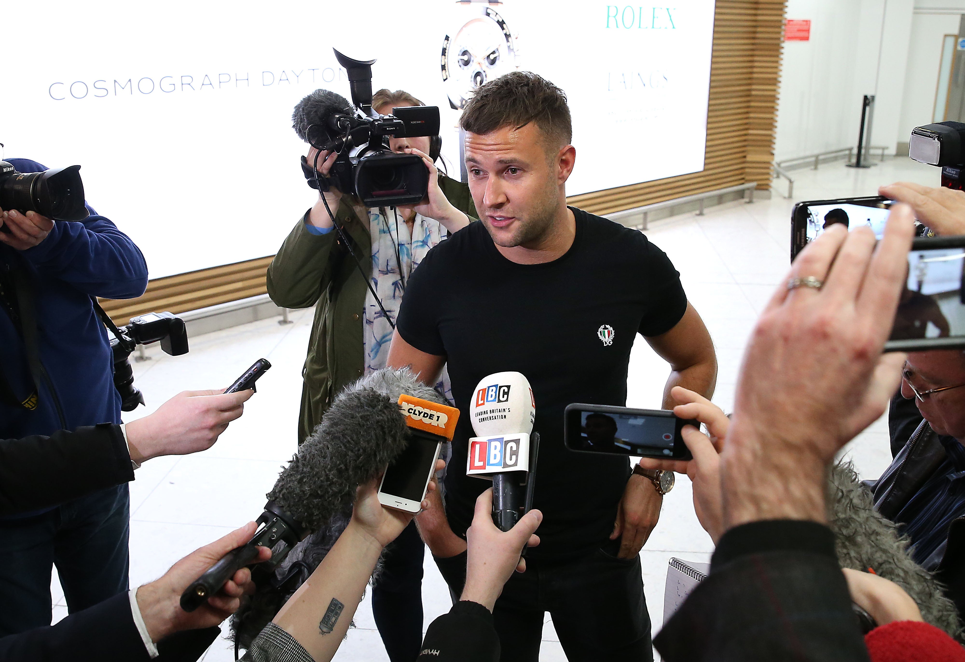 <strong>Jamie Harron, who was sentenced to three months in a Dubai jail for touching a man's hip, arrives at Glasgow Airport after Sheikh Mohammed bin Rashid Al Maktoum made a special order for cases against him to be dismissed.</strong>