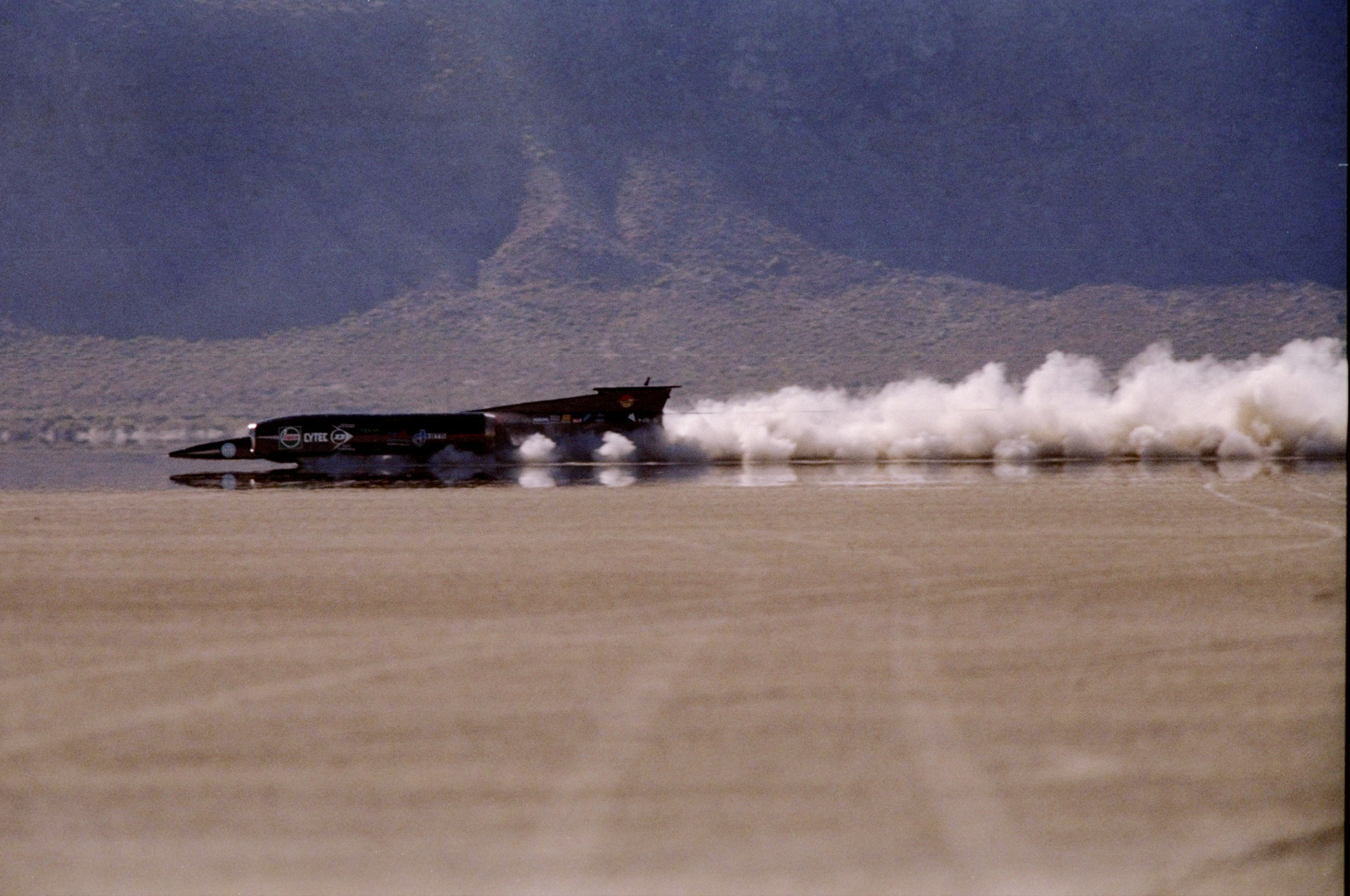 The Thrust SSC Land Speed Racer races down the Nevada desert floor.