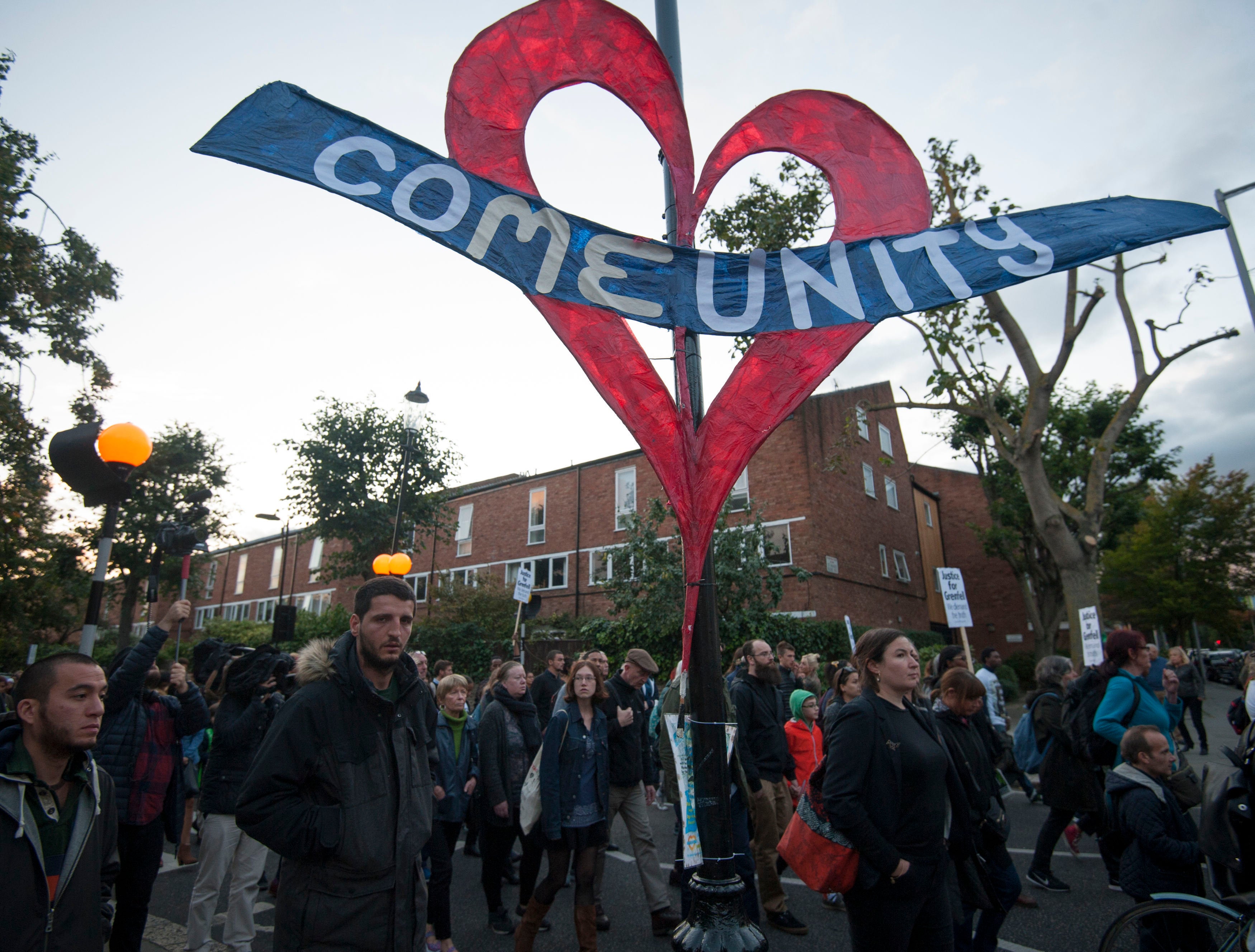 <strong>People take part in a silent march for Grenfell Tower fire victims in west London.</strong>