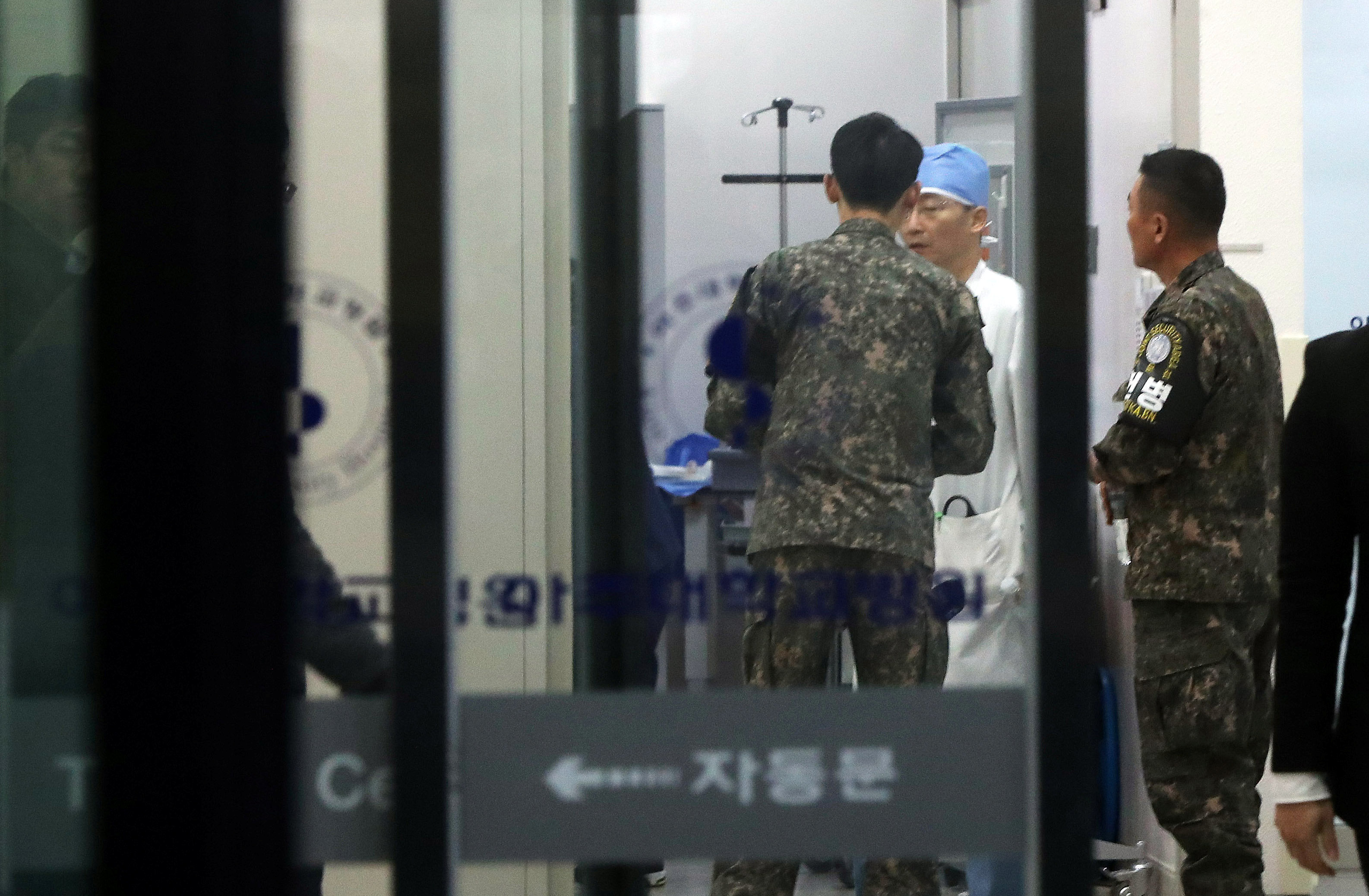 <strong>A South Korean soldier talks with a surgeon at the hospital where the North Korean soldier who defected is being treated&nbsp;</strong>