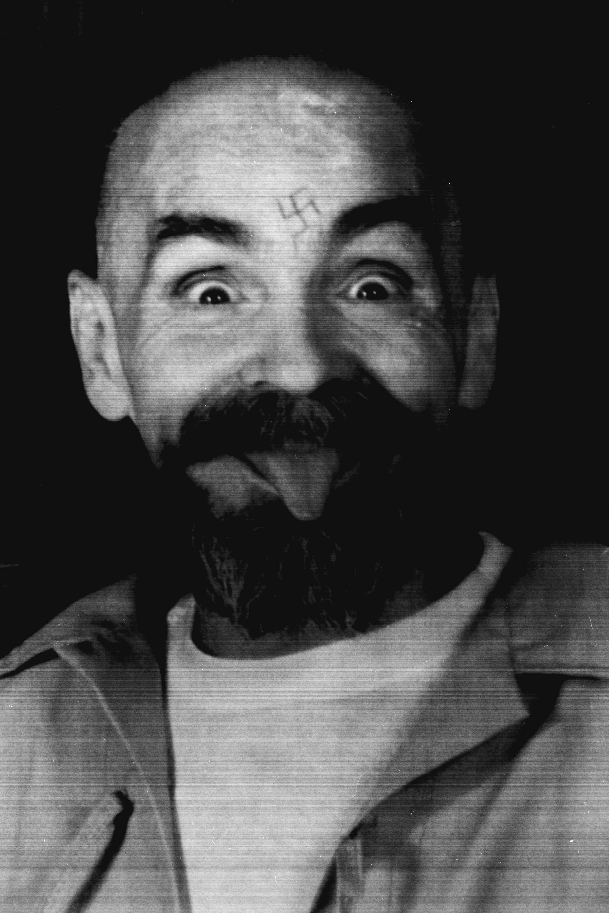 <strong>After shaving his head, Manson, seen above being led to his cell in 1989, told reporters, 'I am the devil, and the devil always has a bald head'</strong>