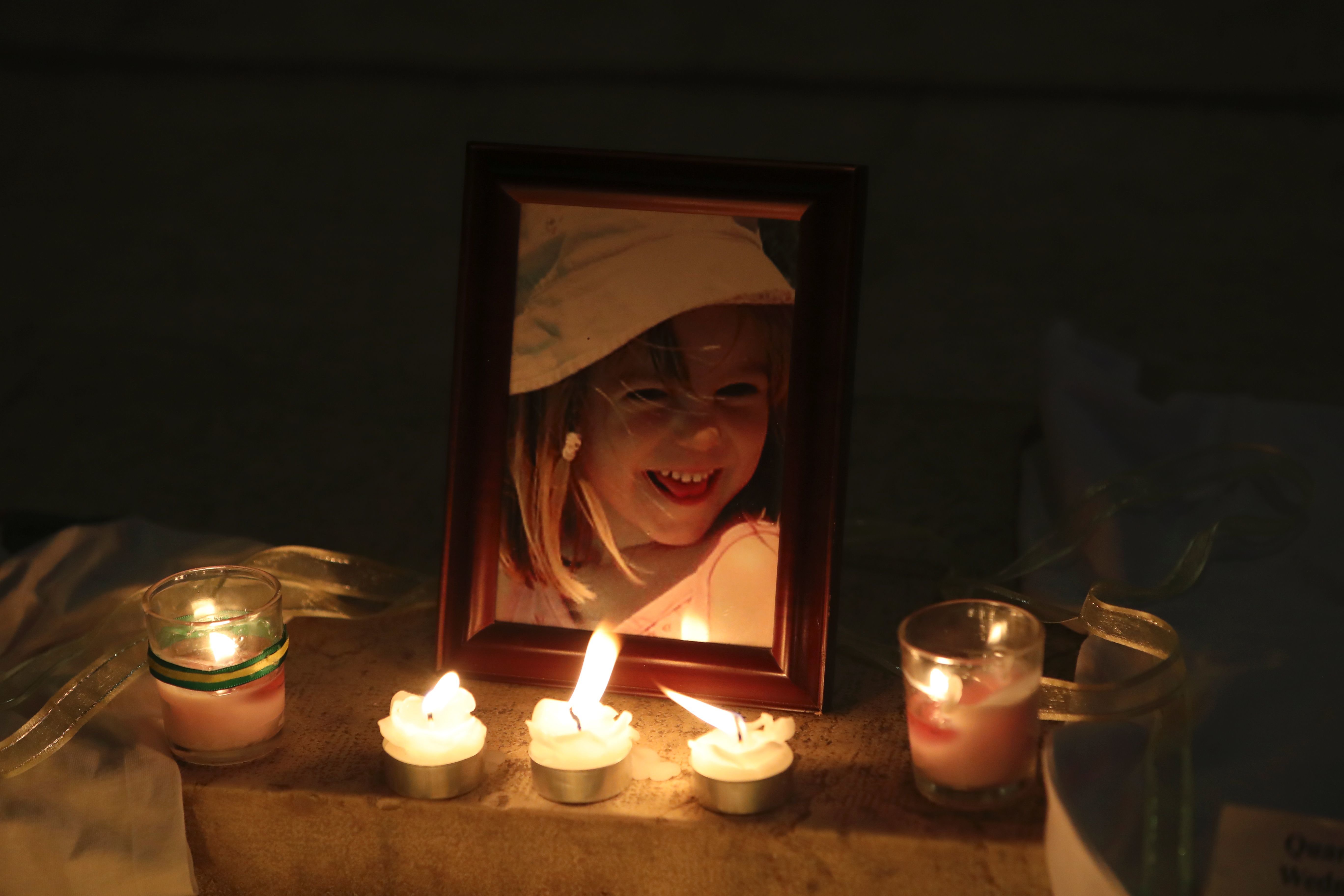 <strong>Candles light a photograph of Madeleine McCann outside a church in Praia da Luz on the tenth anniversary of her disappearance in May&nbsp;</strong>