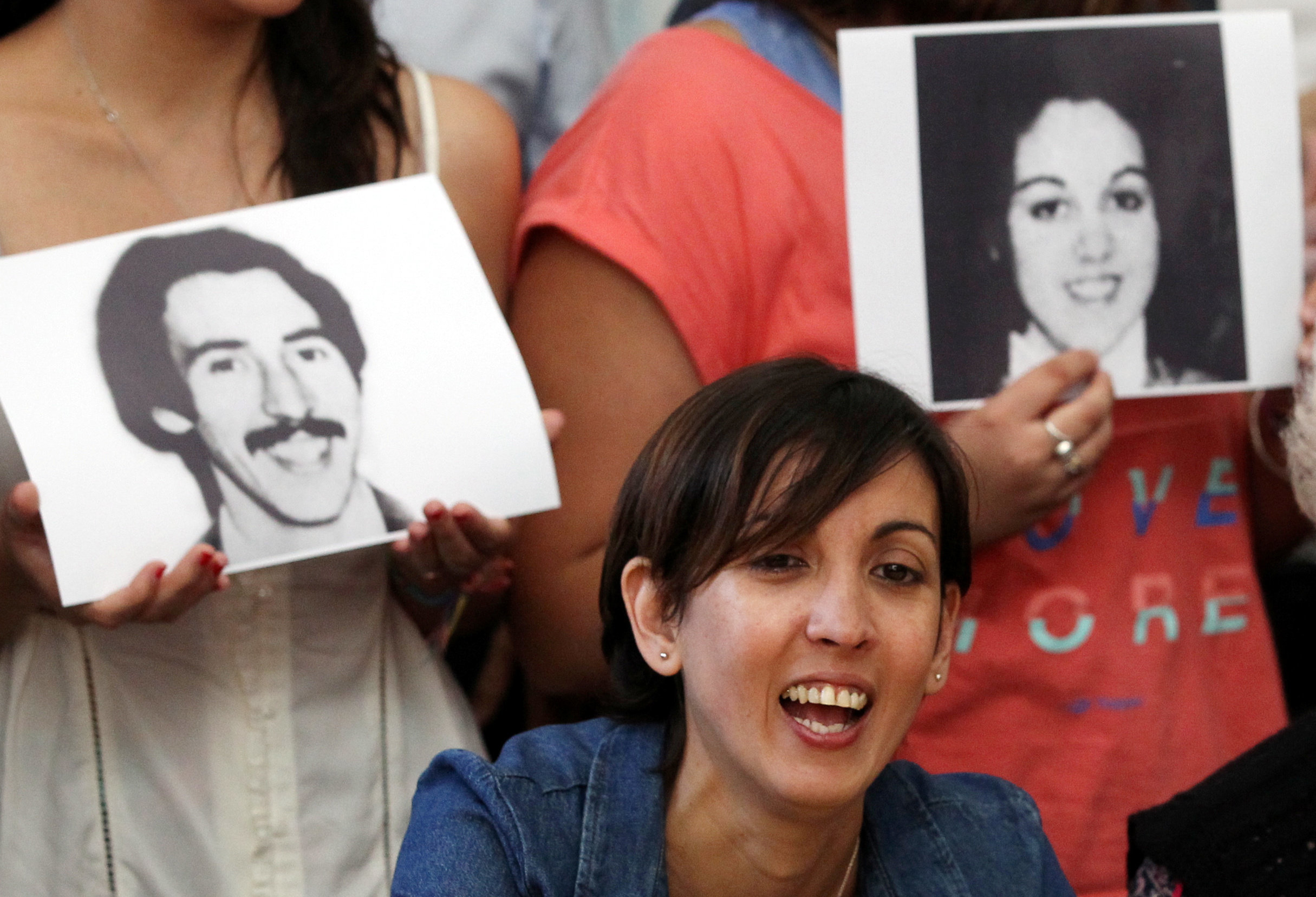 <strong>Adriana flanked with pictures of her parents&nbsp;Violeta Ortolani and Edgardo Garnier, who disappeared in 1977, the year of her birth&nbsp;</strong>