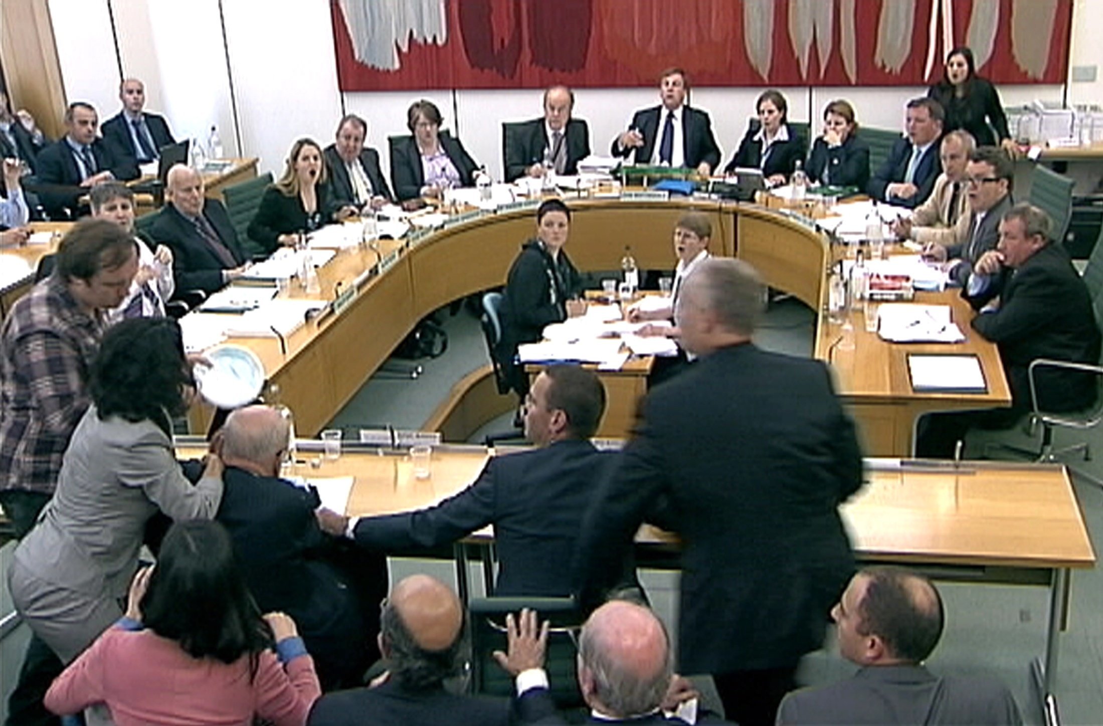 Rupert Murdoch gets pied in the face during a Commons select committee
