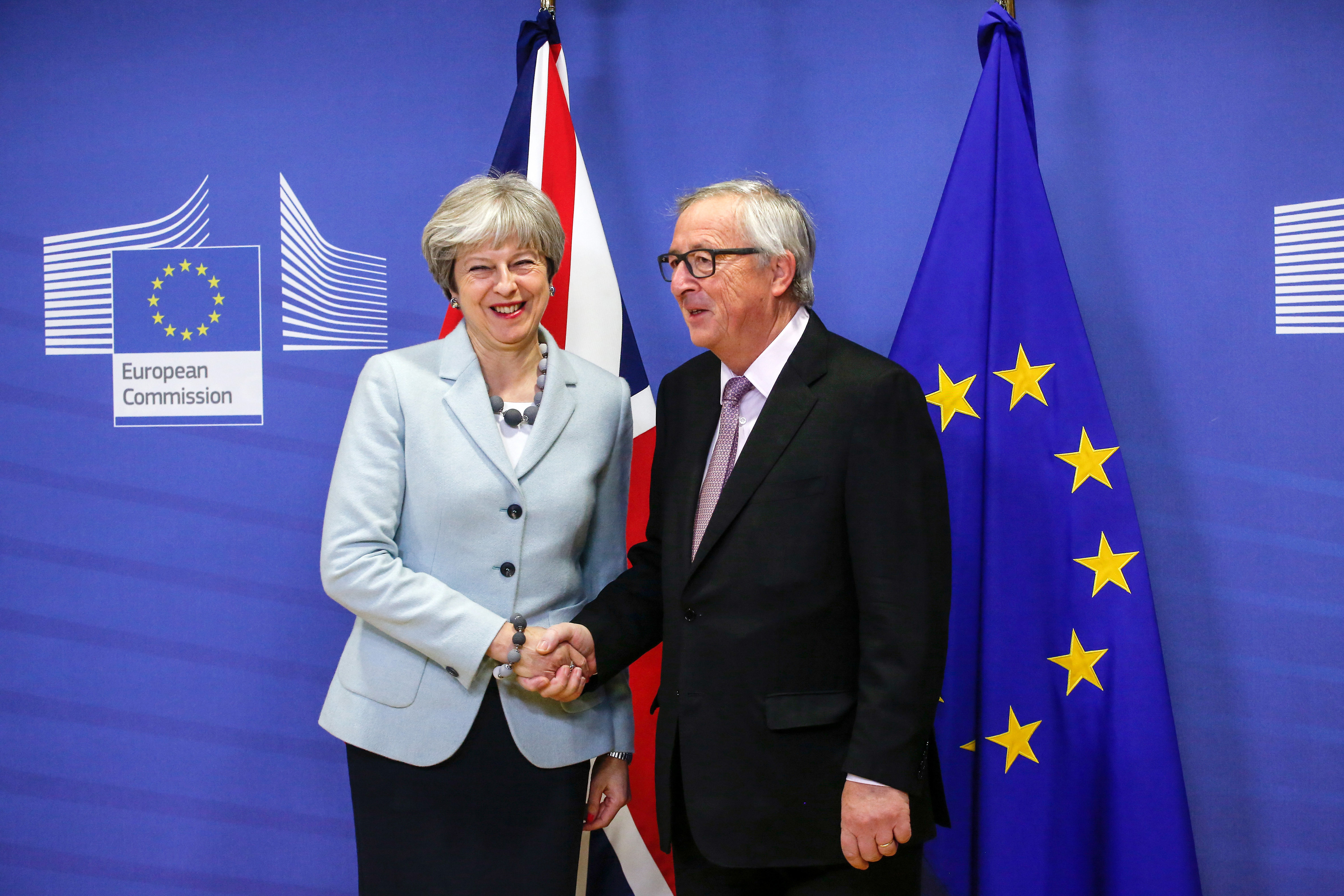 Theresa May shakes hands with European Commission President Jean-Claude Juncker.