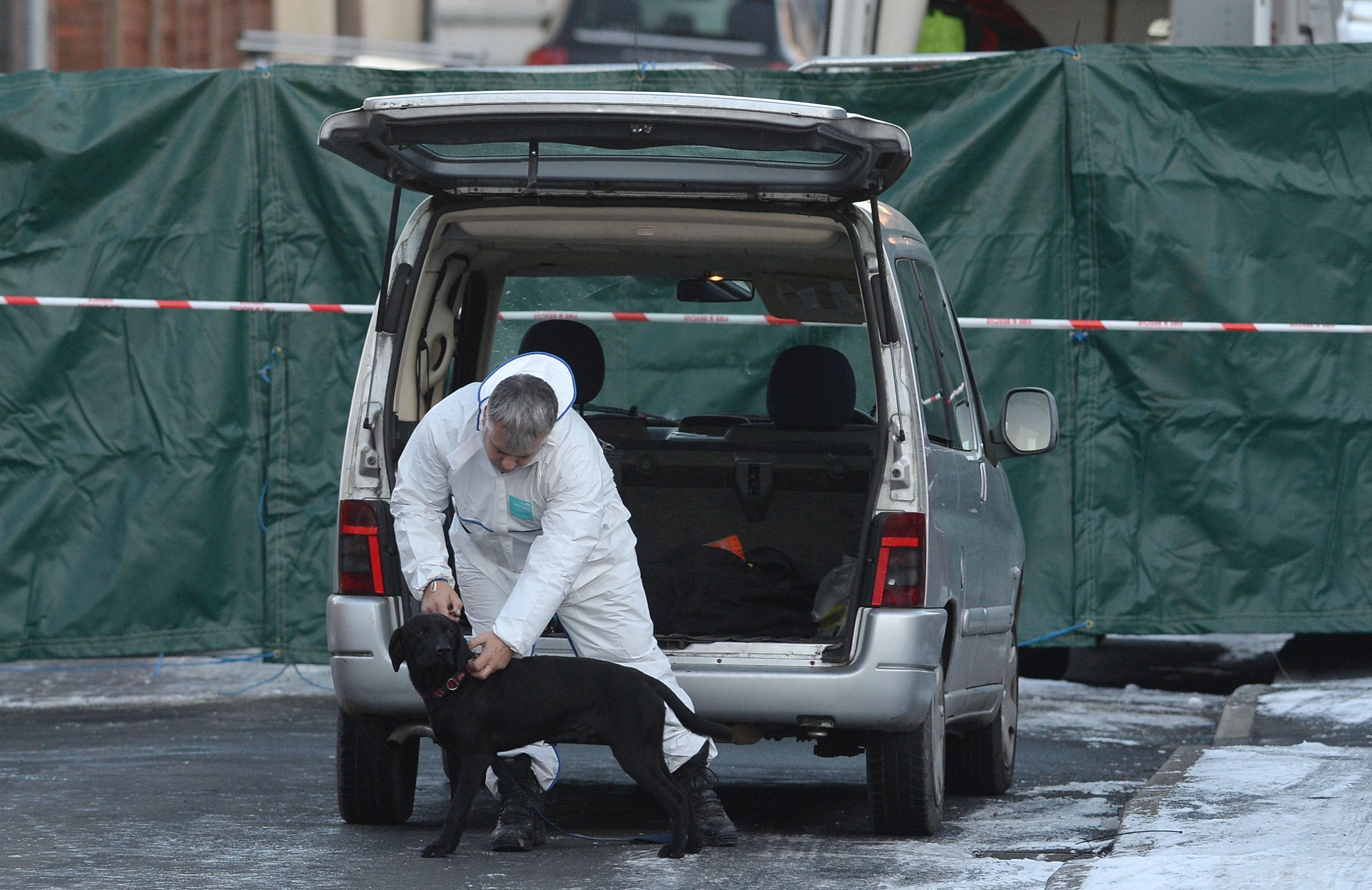 <strong>A forensic officer with a dog at the scene of the house fire on Jackson Street in Worsley.</strong>