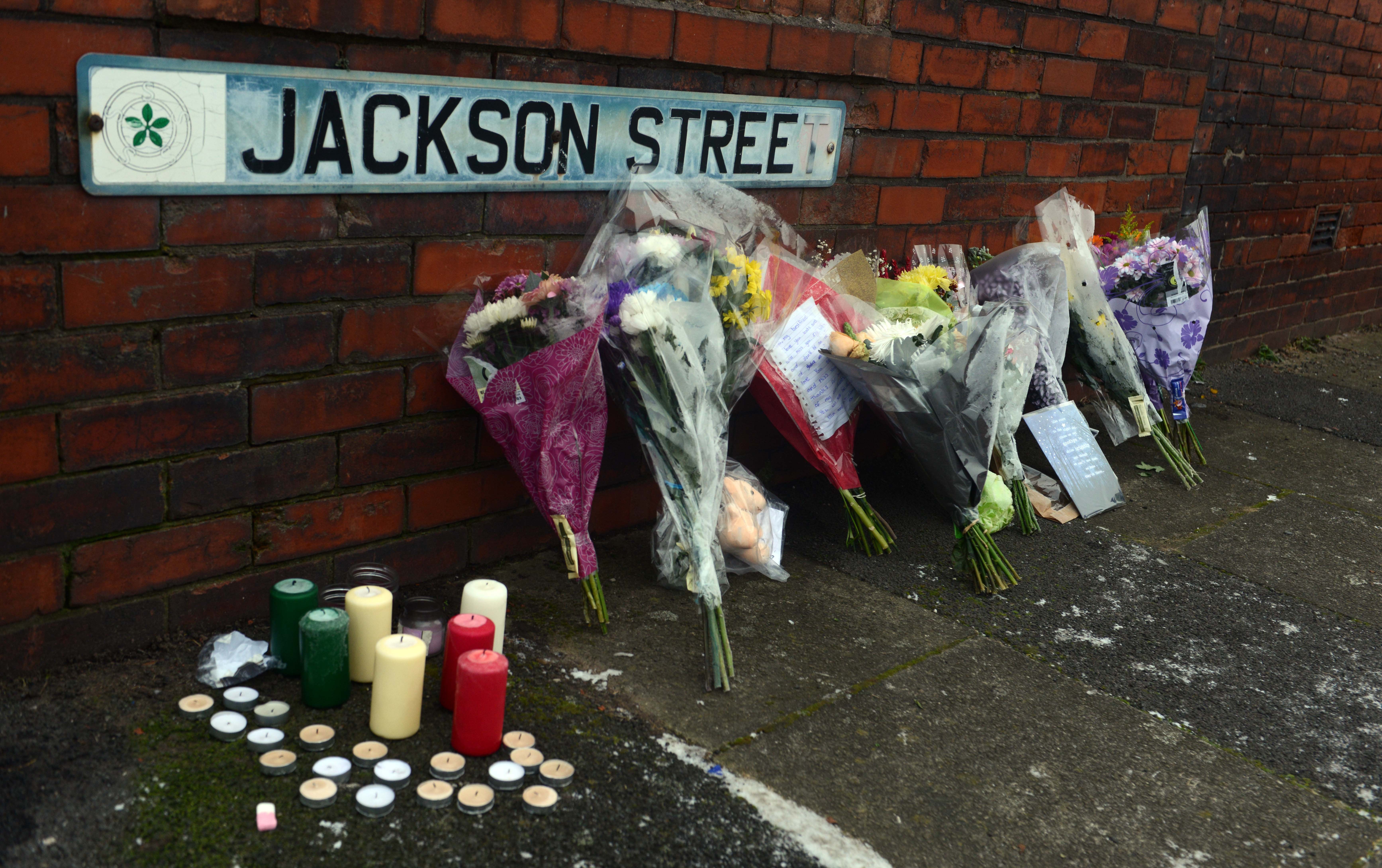 <strong>Neighbours and friends have been leaving floral tributes and candles near the family home </strong>