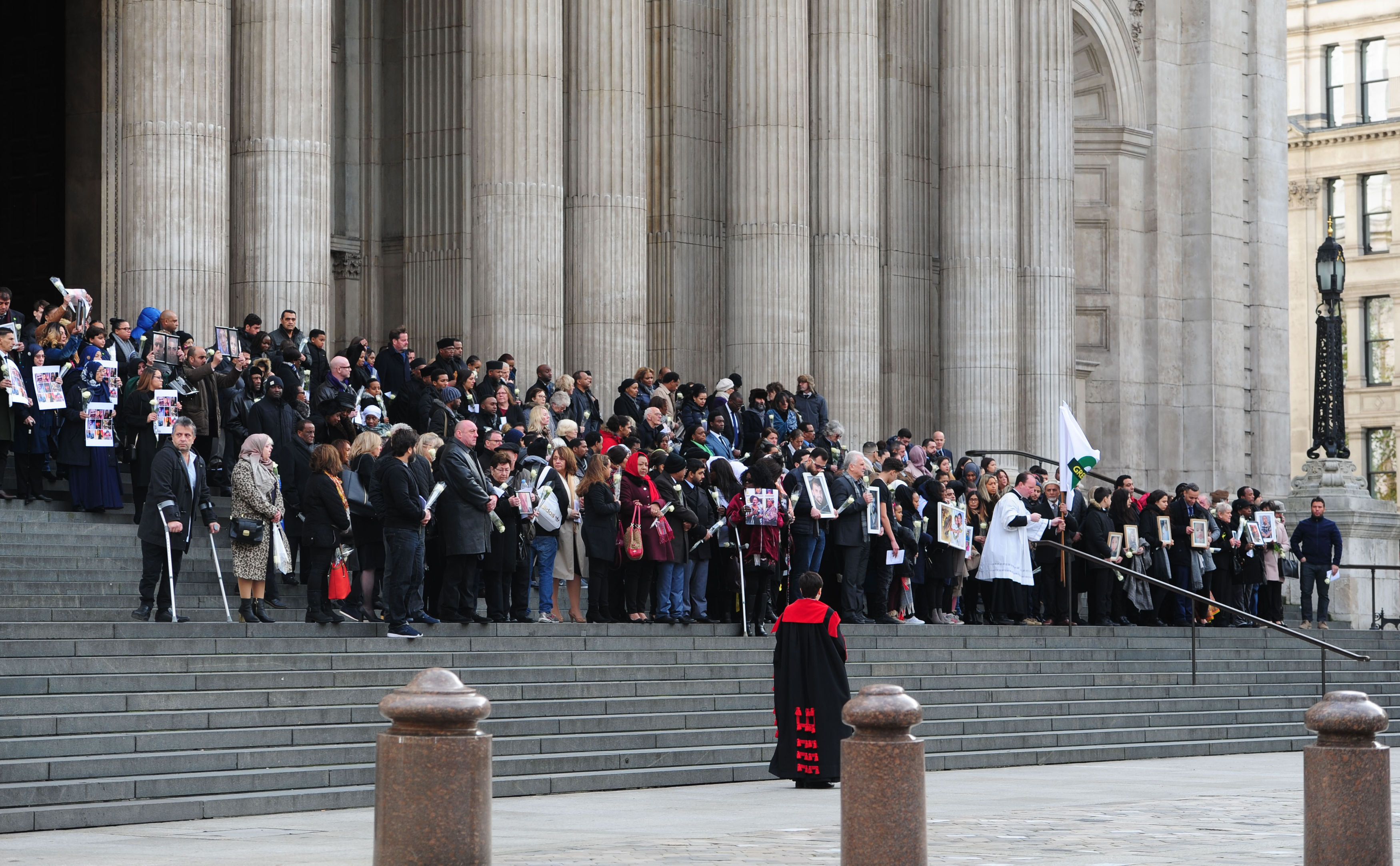 People gather on the steps as they leave after the service at St Paul's Cathedral