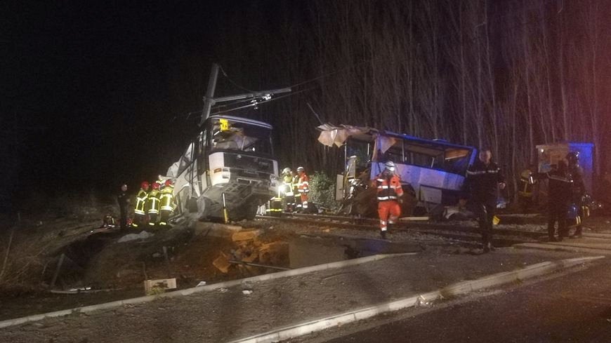 <strong>Rescue workers are seen on the site of collision between train and school bus in Millas.</strong>