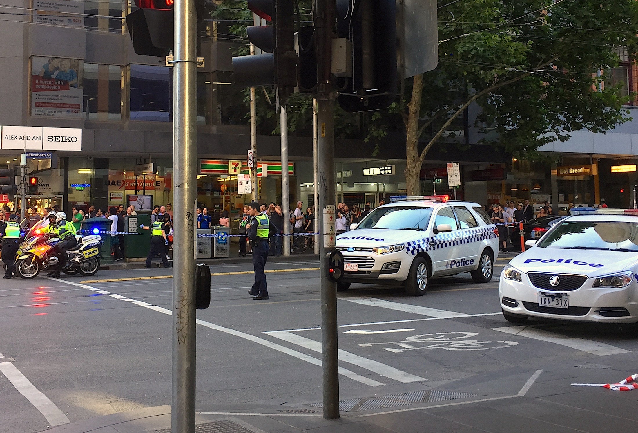 <strong>Police officers secure the area as members of the public stand behind police tape after a vehicle ploughed into pedestrians.</strong>