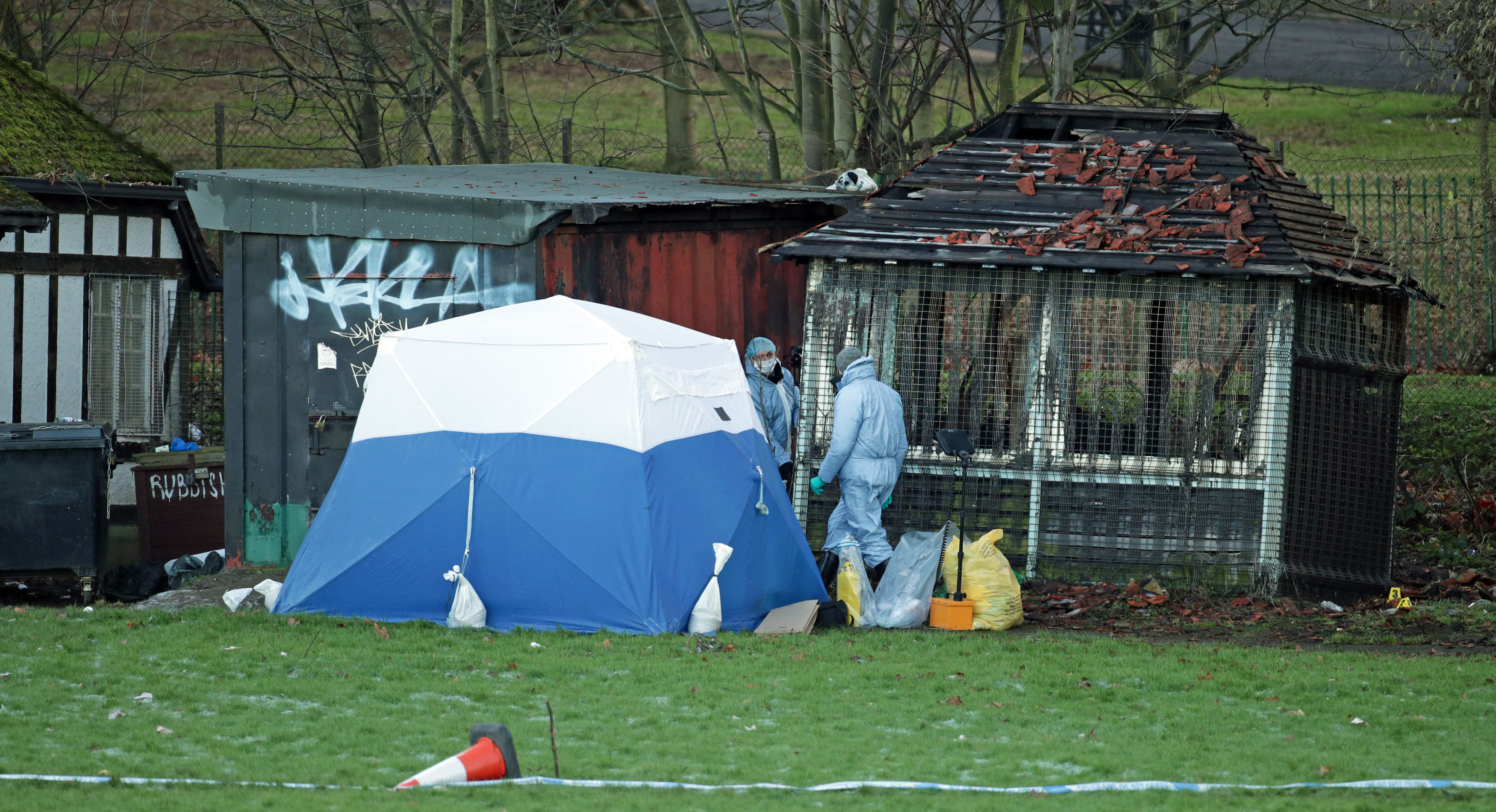 <strong>Police investigators work in Finsbury Park after a woman's body was found in a building by the sports ground in the middle of the park.</strong>