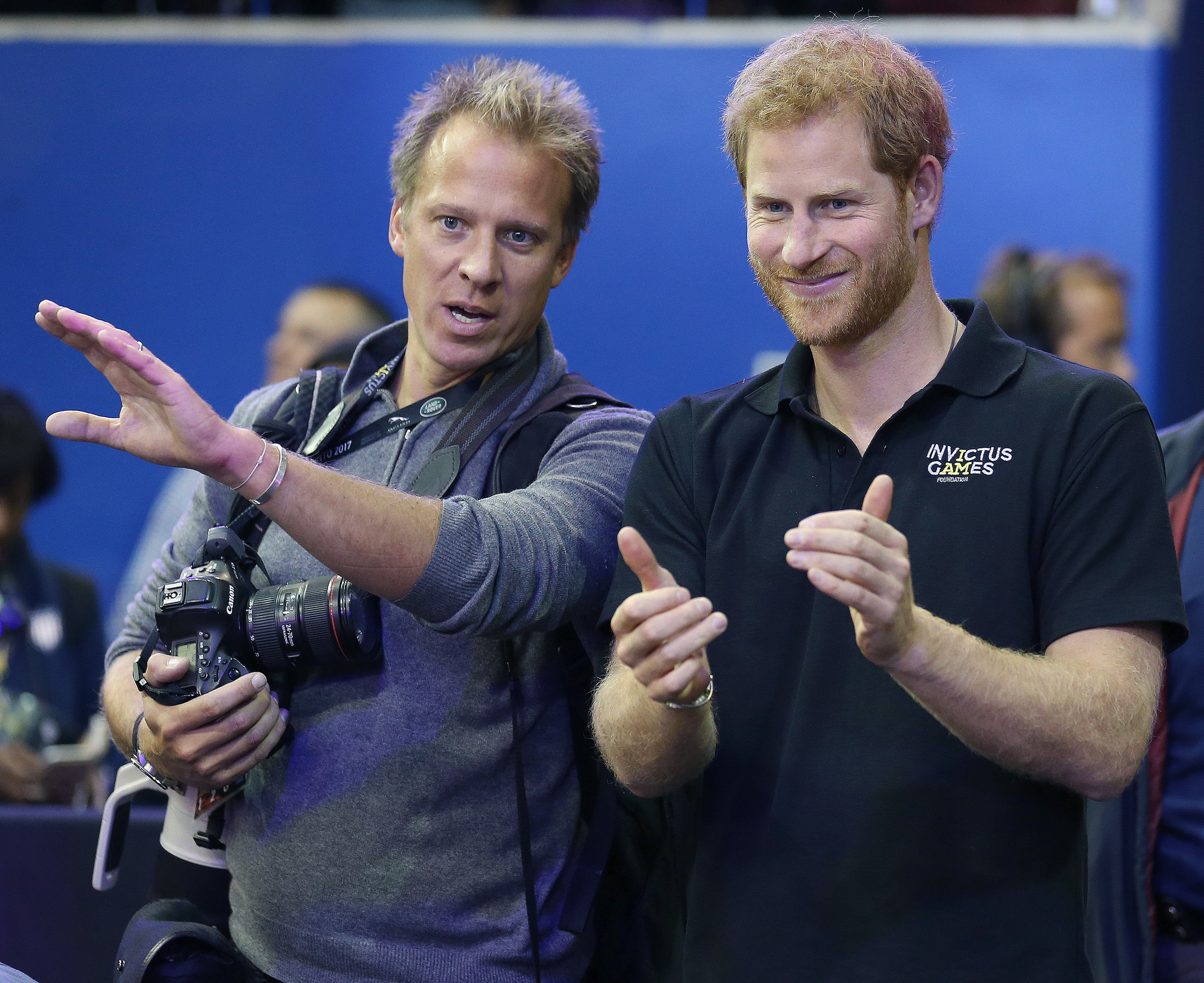 Chris Jackson (left) goes over the medal ceremony order with Prince Harry during the 2017 Invictus Games