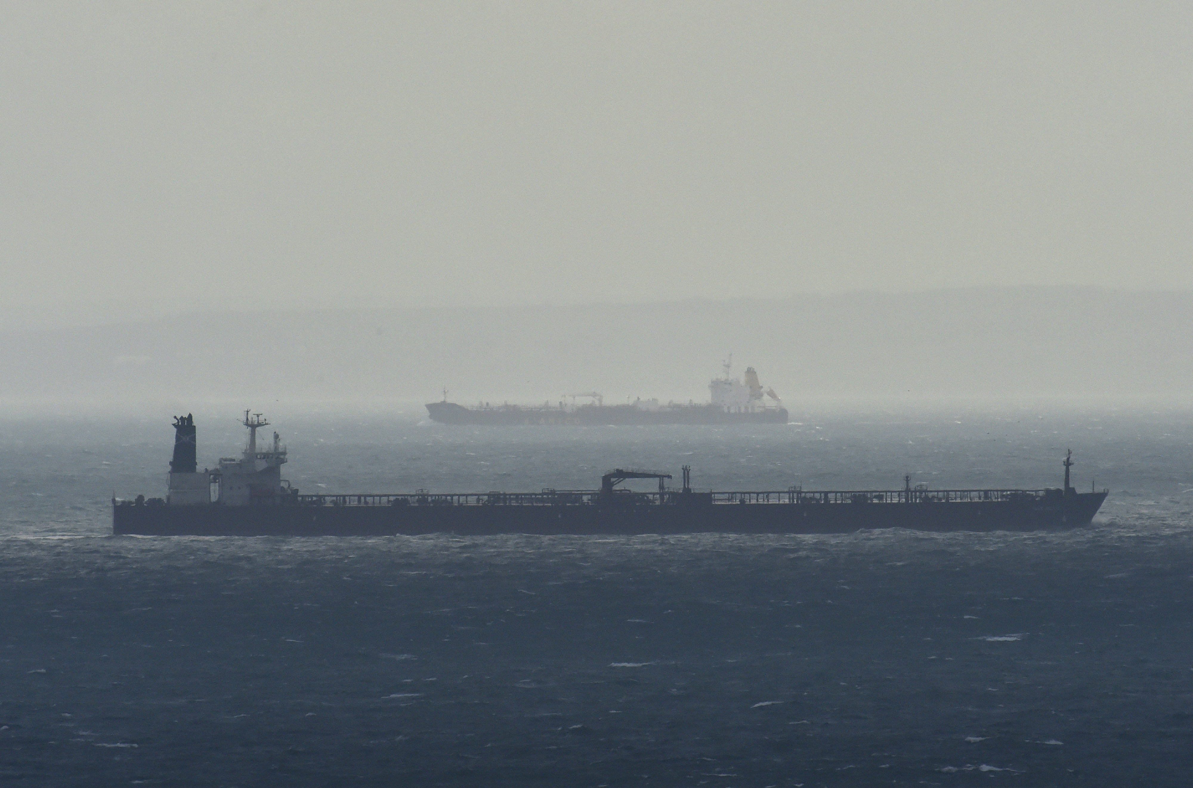 <strong>Cargo ships are seen as they sail across the English Channel with the French coast</strong>