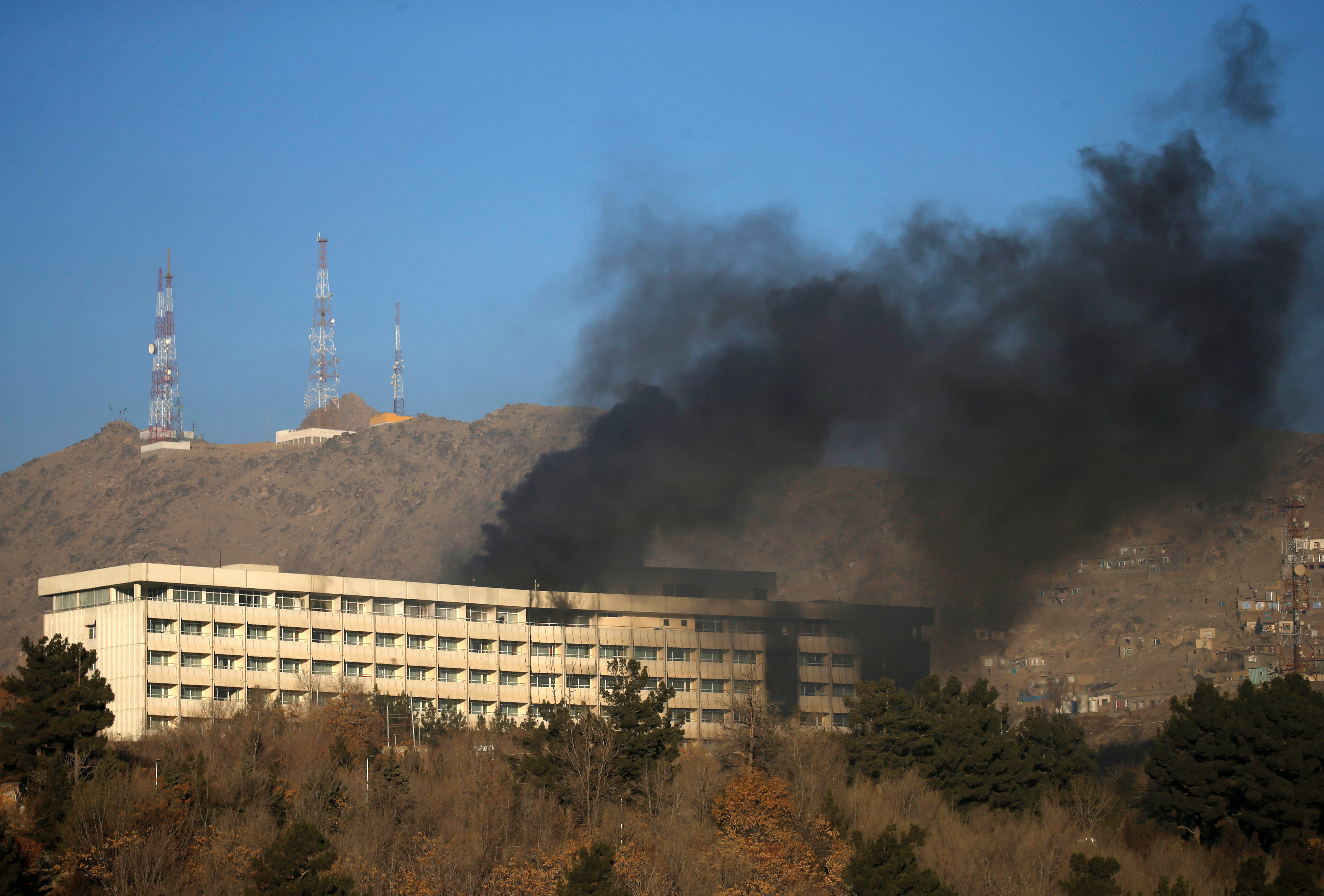 <strong>Smoke rises from the top of the hotel where three attackers were shot dead</strong>