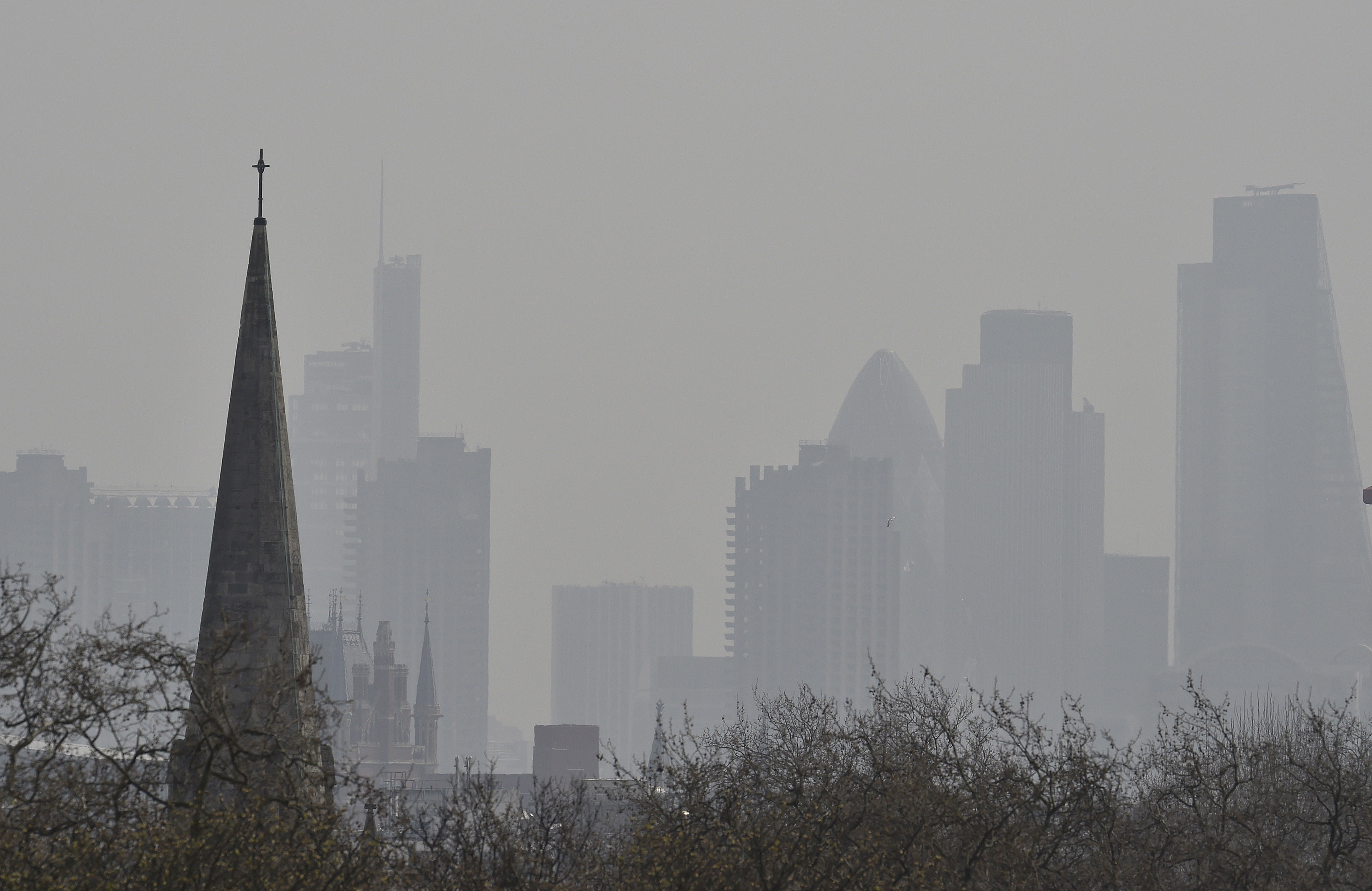 <strong>The UK&rsquo;s poorest communities are being hit the hardest by air pollution; London's financial district is seen above, obscured by air pollution</strong>