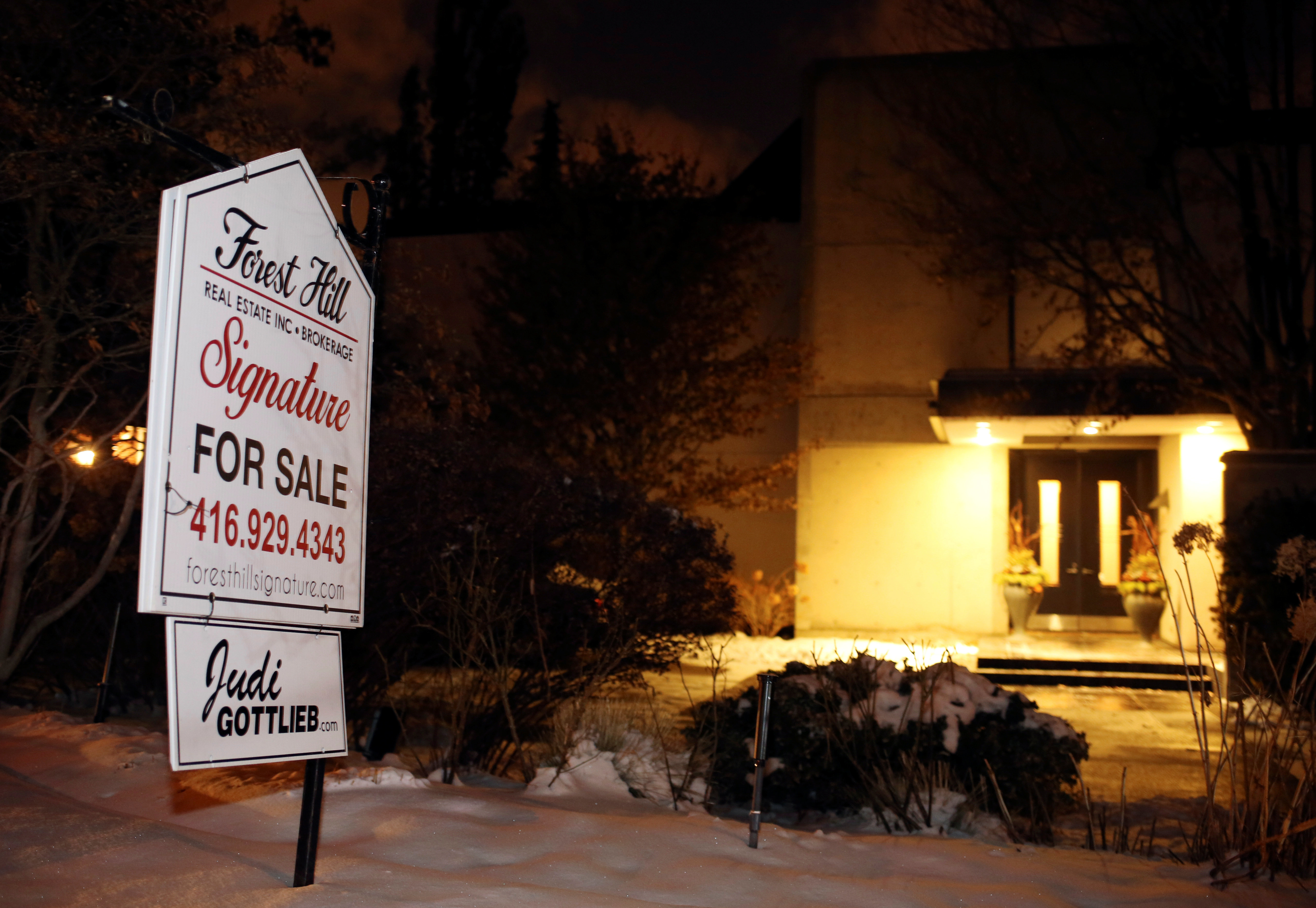 <strong>A for sale sign stands outside the Sherman's former home where they were found dead in December</strong>