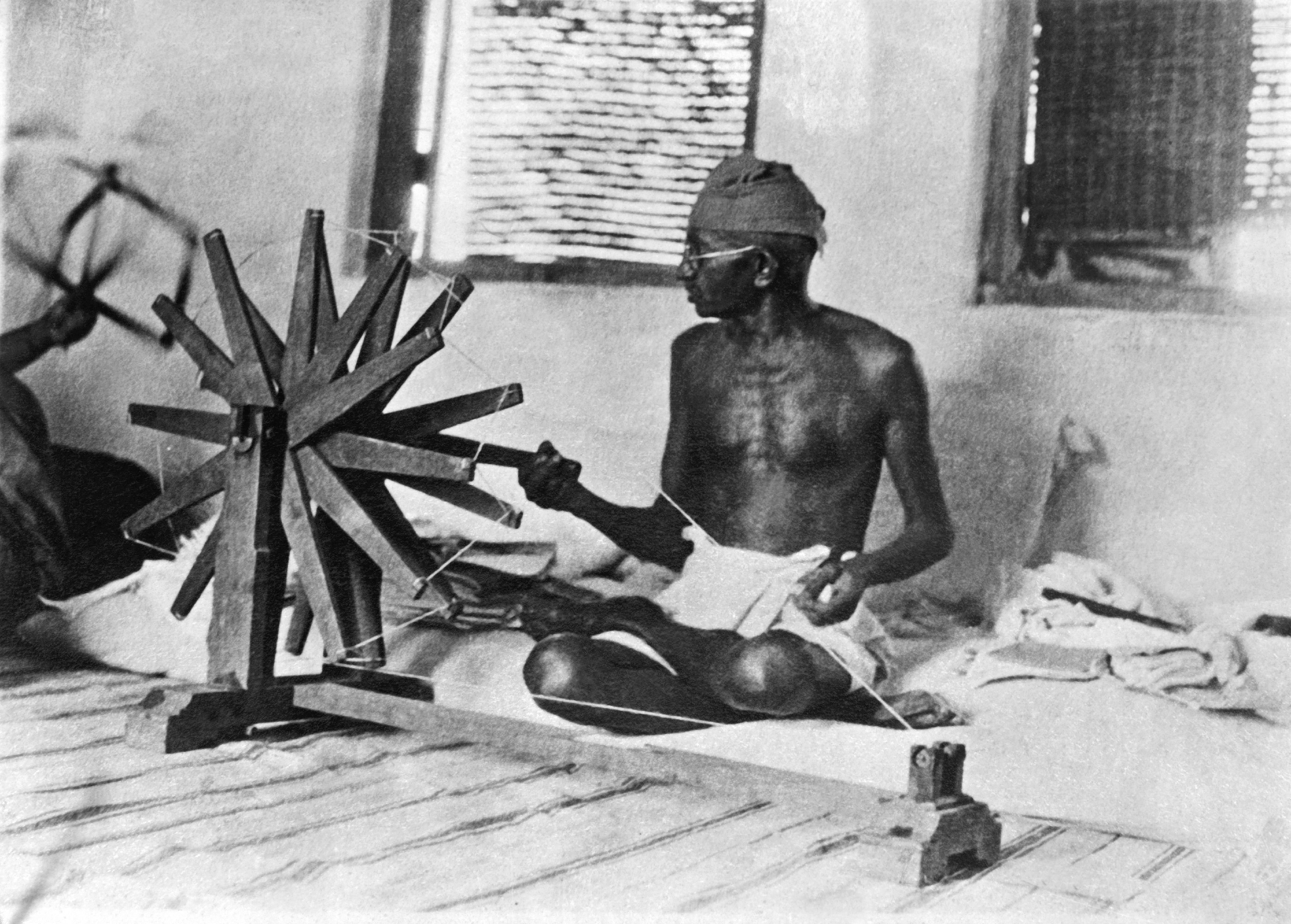 <strong>Gandhi making homespun cotton to boycott English merchandise and boost Indian economic self-sufficiency&nbsp;</strong>