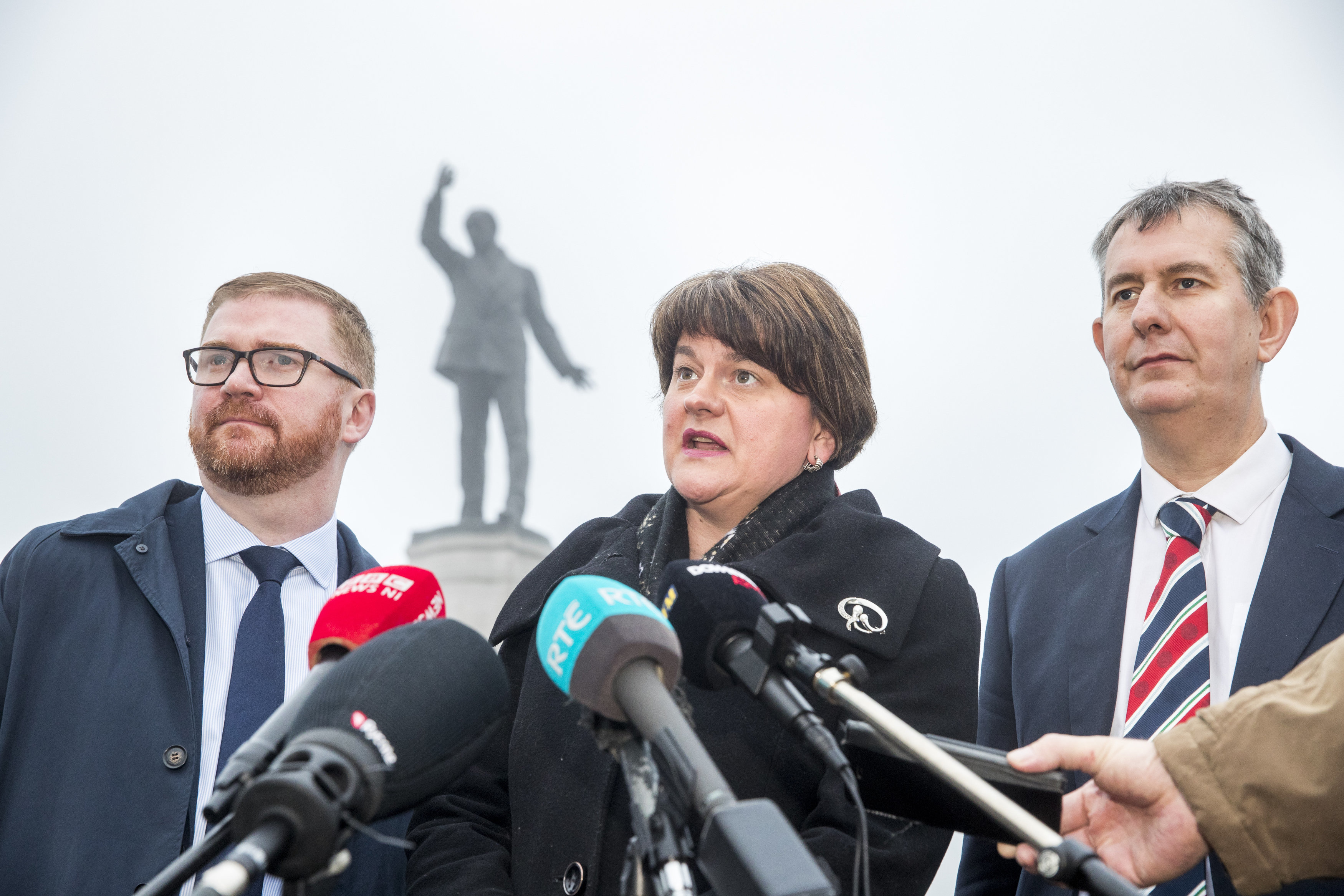 <strong>DUP leader Arlene Foster, with party colleagues Simon Hamilton and Edwin Poots (right), speaks with media at Carson Statue</strong>