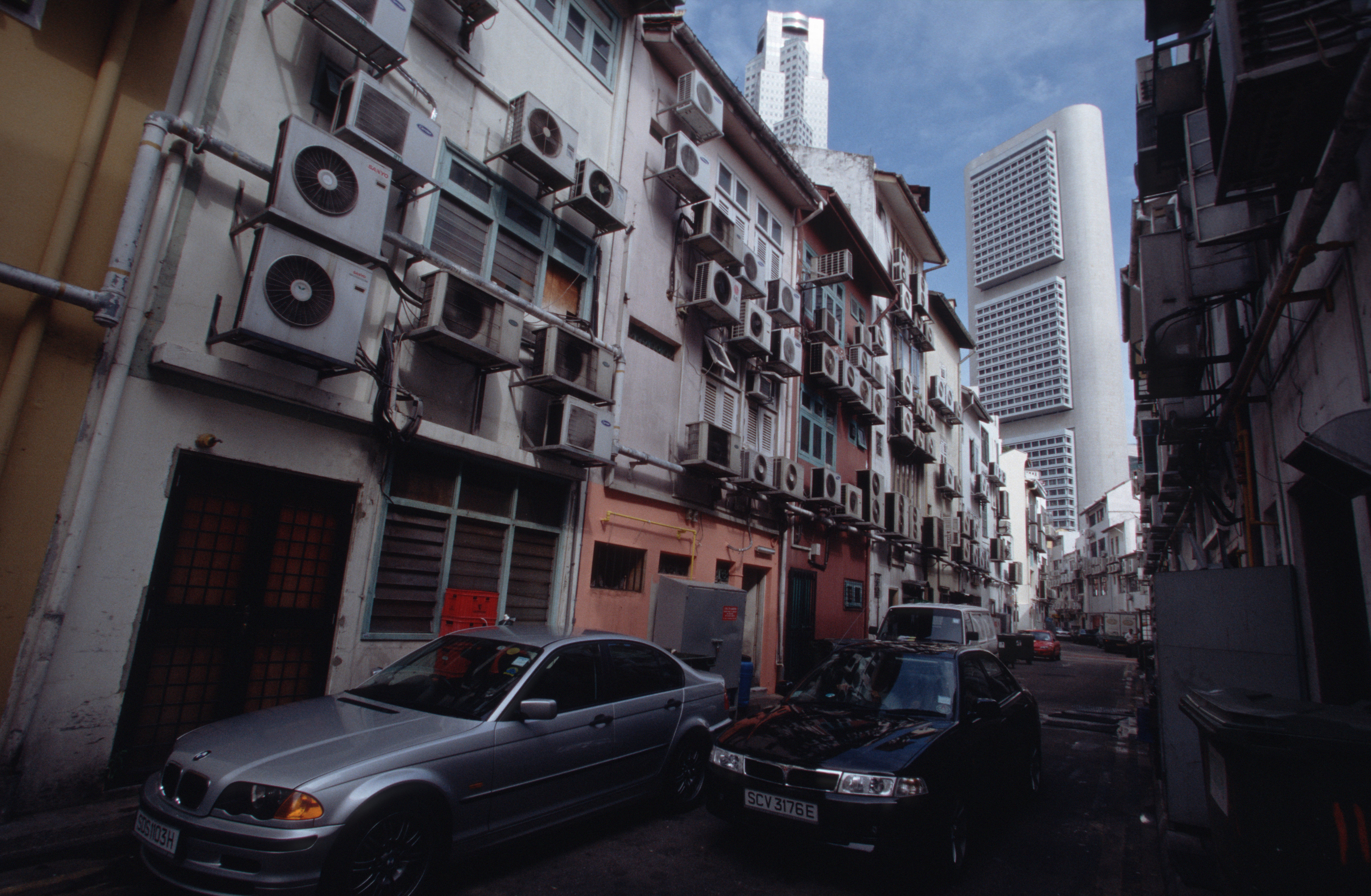 A mass of air conditioning units hang off the back side of a row of buildings that open onto the fashionable Boat Quay area. In Singapore's tropical climate, air conditioning has become a must.