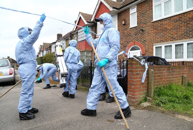 Forensic officers at the scene in South Park Crescent in Hither Green, London, after a suspected burglar was stabbed there and died