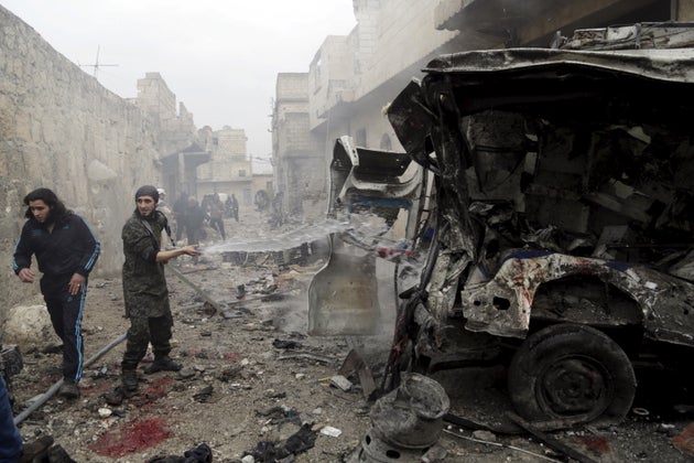 A man sprays water on an ambulance at a site hit by what activists said were three consecutive air strikes carried out by the Russian air force, the last which hit this vehicle, in the rebel-controlled area of Maaret al-Numan town in Idlib province, Syria January 12,