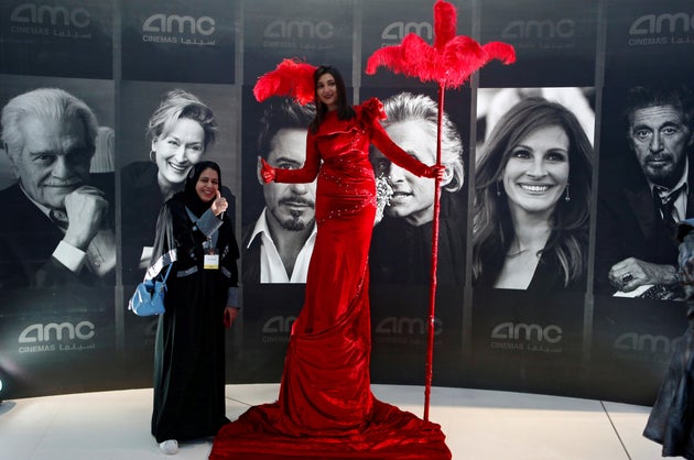 A woman poses at Saudi Arabia's first new commercial movie theater in Riyadh on April 18, 2018.