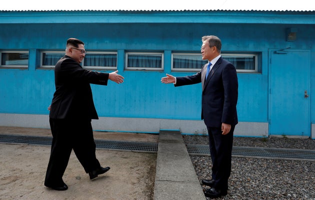 South Korean President Moon Jae-in and North Korean leader Kim Jong Un shake hands at the truce village of Panmunjom inside the demilitarized zone separating the two Koreas.
