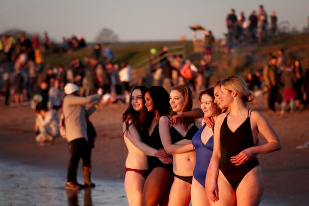 Students from the University of St Andrews take part in the traditional May Day Dip on the East Sands in St Andrews, Fife