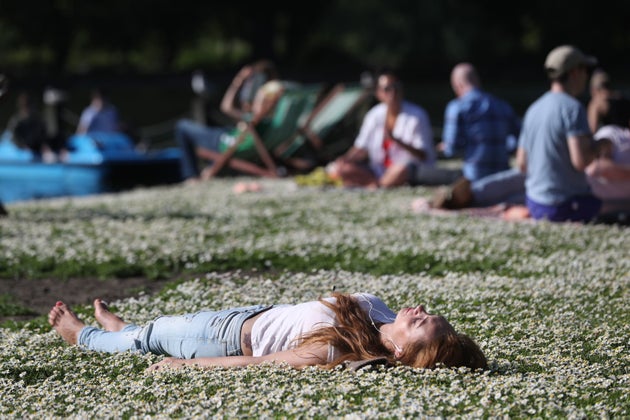 A woman enjoys the sun in Regent's Park London, on Saturday. This weekend's temperatures are set to break records.