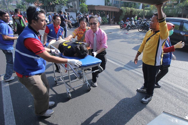 A person injured from a blast at the Indonesian Christian Church is evacuated to a waiting ambulance in Surabaya, East Java, Indonesia May 13, 2018.