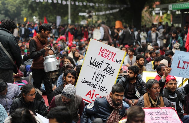 A tea vendor sells tea to Indian students participating in a protest rally in New Delhi, on Feb. 7, 2019. The march called