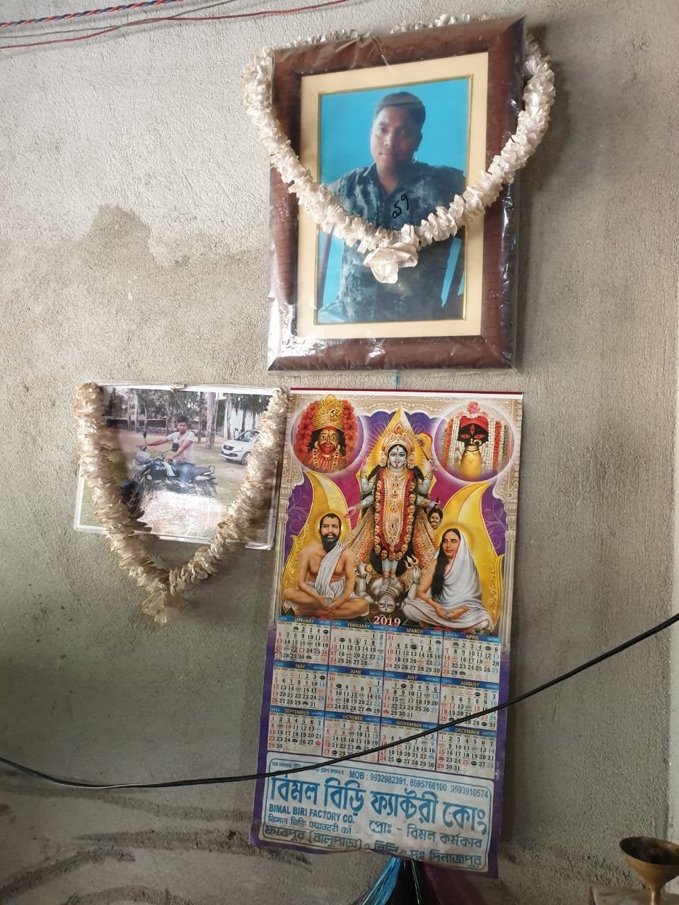 Photos of Tapas displayed on the wall of the sweet shop that he started, and now his father runs.