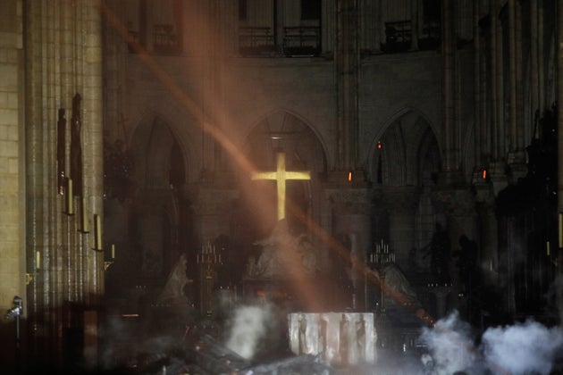 Smoke rises around the altar inside Notre Dame.