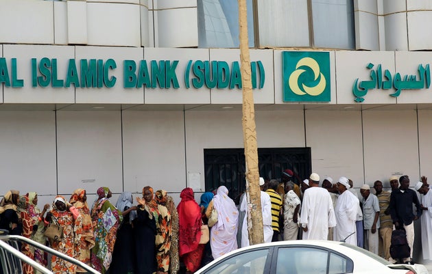 Sudanese customers queue to access money services at the Faisal Islamic Bank in Khartoum on June 11, 2019