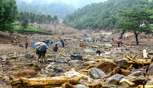 Volunteers, local residents and members of National Disaster Response Force (NDRF) search for survivors in the debris left by a landslide at Puthumala at Meppadi in the Wayanad district of Kerala on August 10.