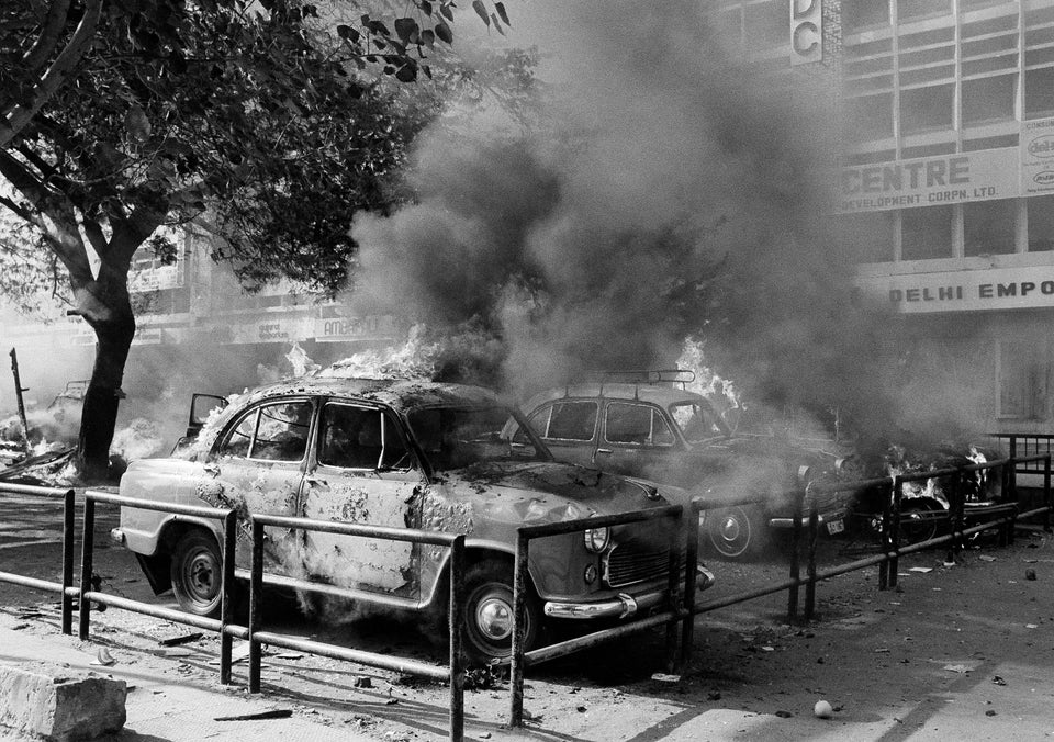 A fleet of Sikh owned cars burn and are covered in thick black smoke after they were set on fire in New Delhi, 1 November, 1984.