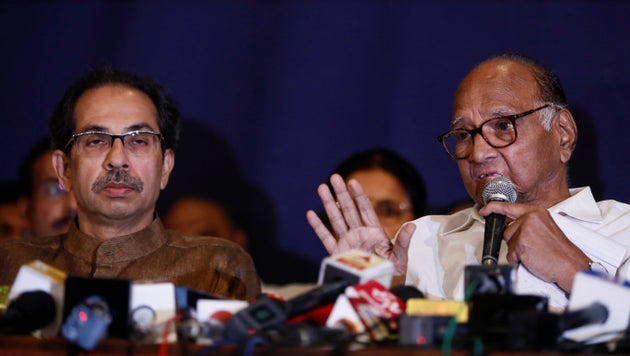 Nationalist Congress Party president Sharad Pawar speaks at a news conference as Shiv Sena chief Uddhav Thackeray looks on in Mumbai, India, November 23, 2019. REUTERS/Francis Mascarenhas