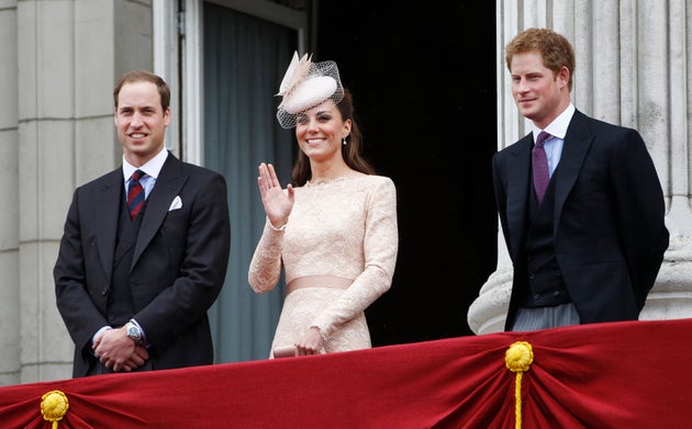 The Duchess of Cambridge waves from the balcony of Buckingham Palace as William and Harry look on, during the Queen's Diamond Jubilee on June 5, 2012.